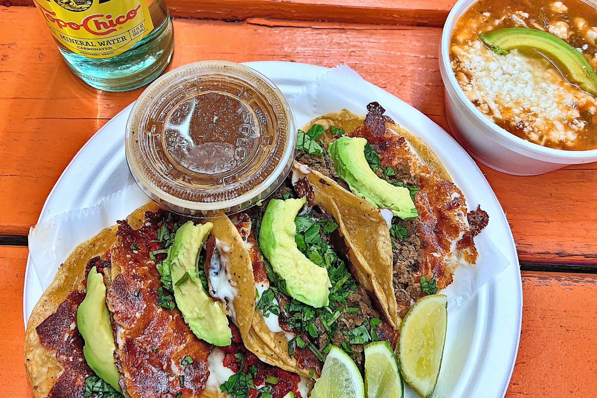 A plate with four tacos at Oye Taquito in Austin