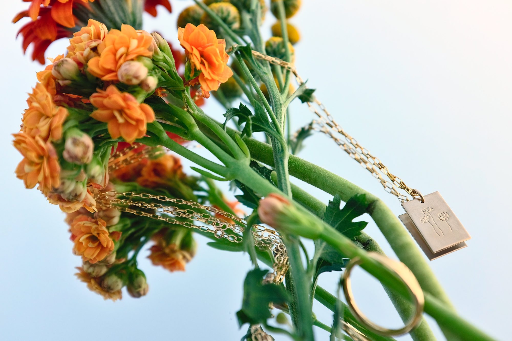 GLDN's Marseille necklace is in focus, mixed in with a bouquet of floweres