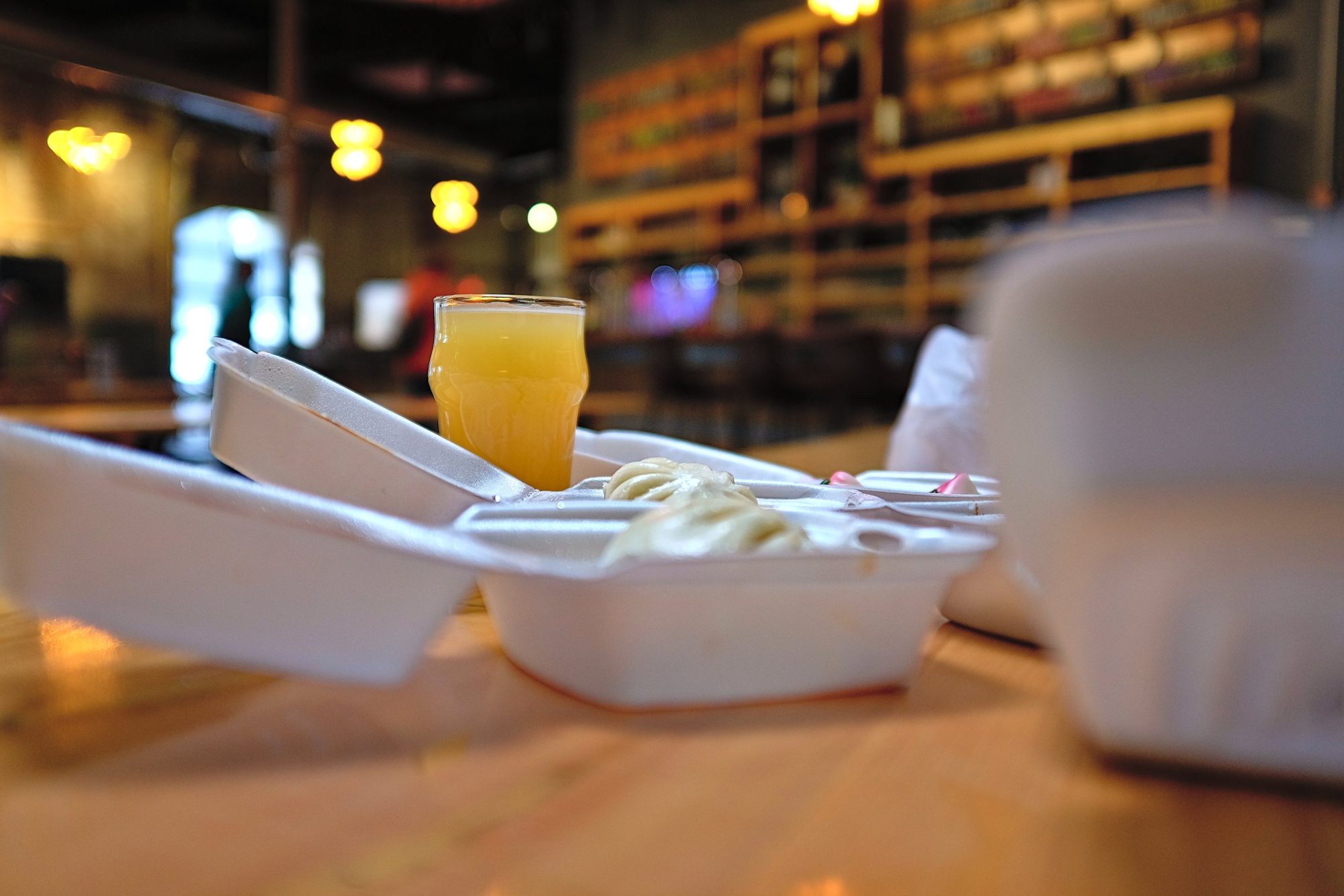 Takeout boxes and a beer at Joymongers Barrel Hall