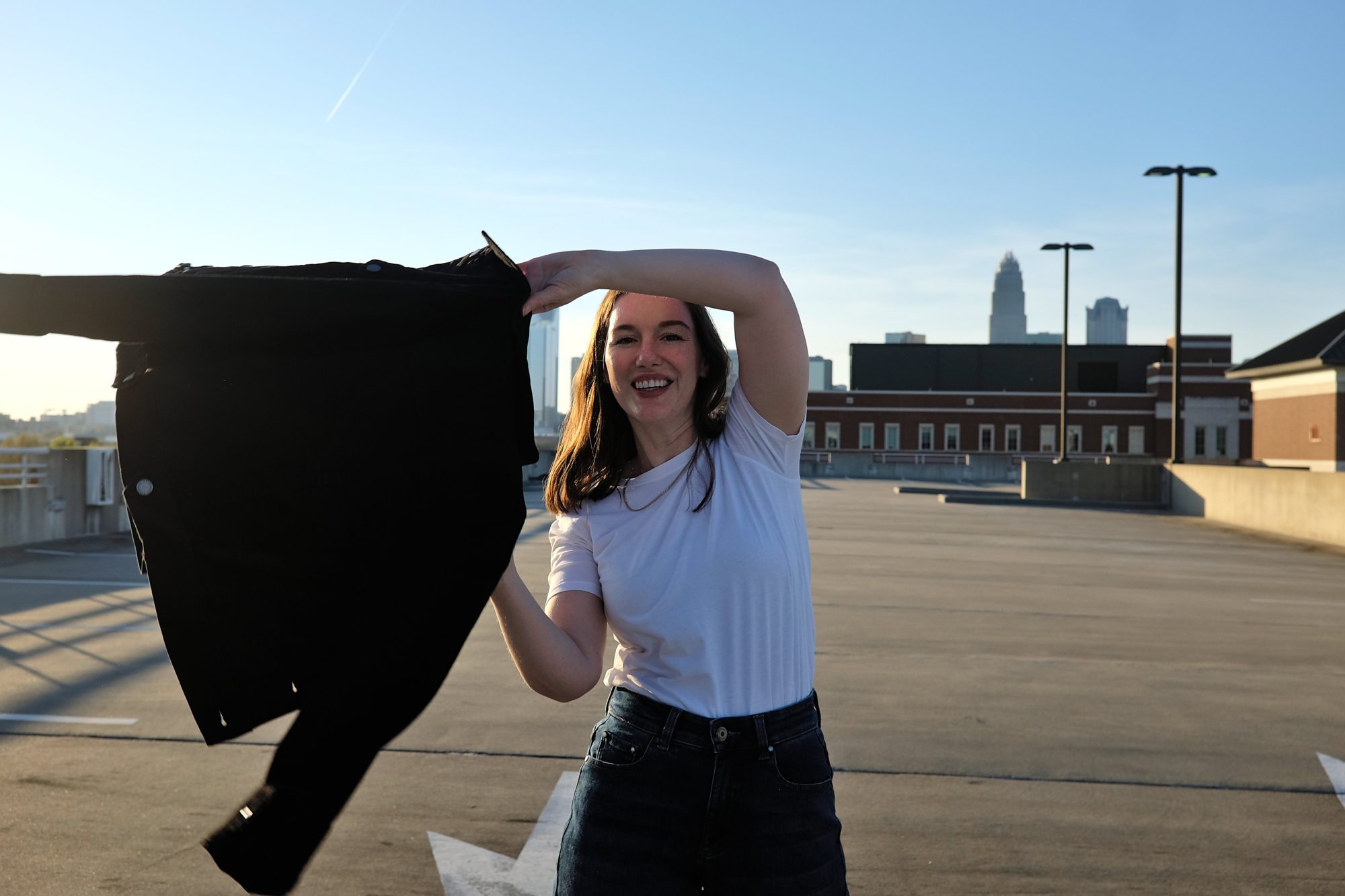 Alyssa swings the Kelsey Denim jacket around to put it on