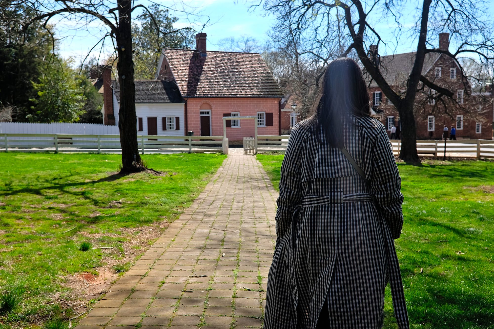 Alyssa walks down a path in Old Salem