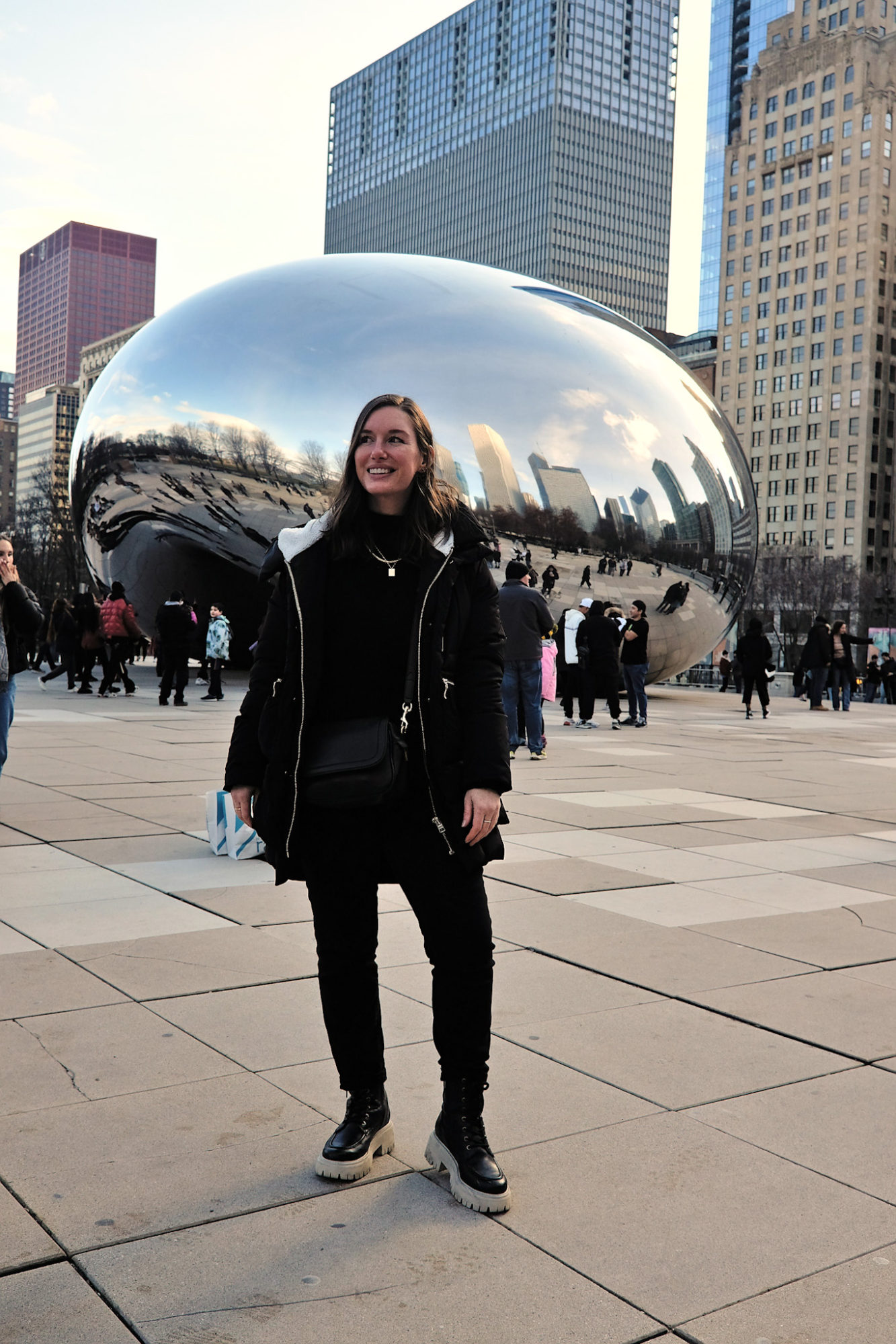 Alyssa wears all black and stands in front of the bean