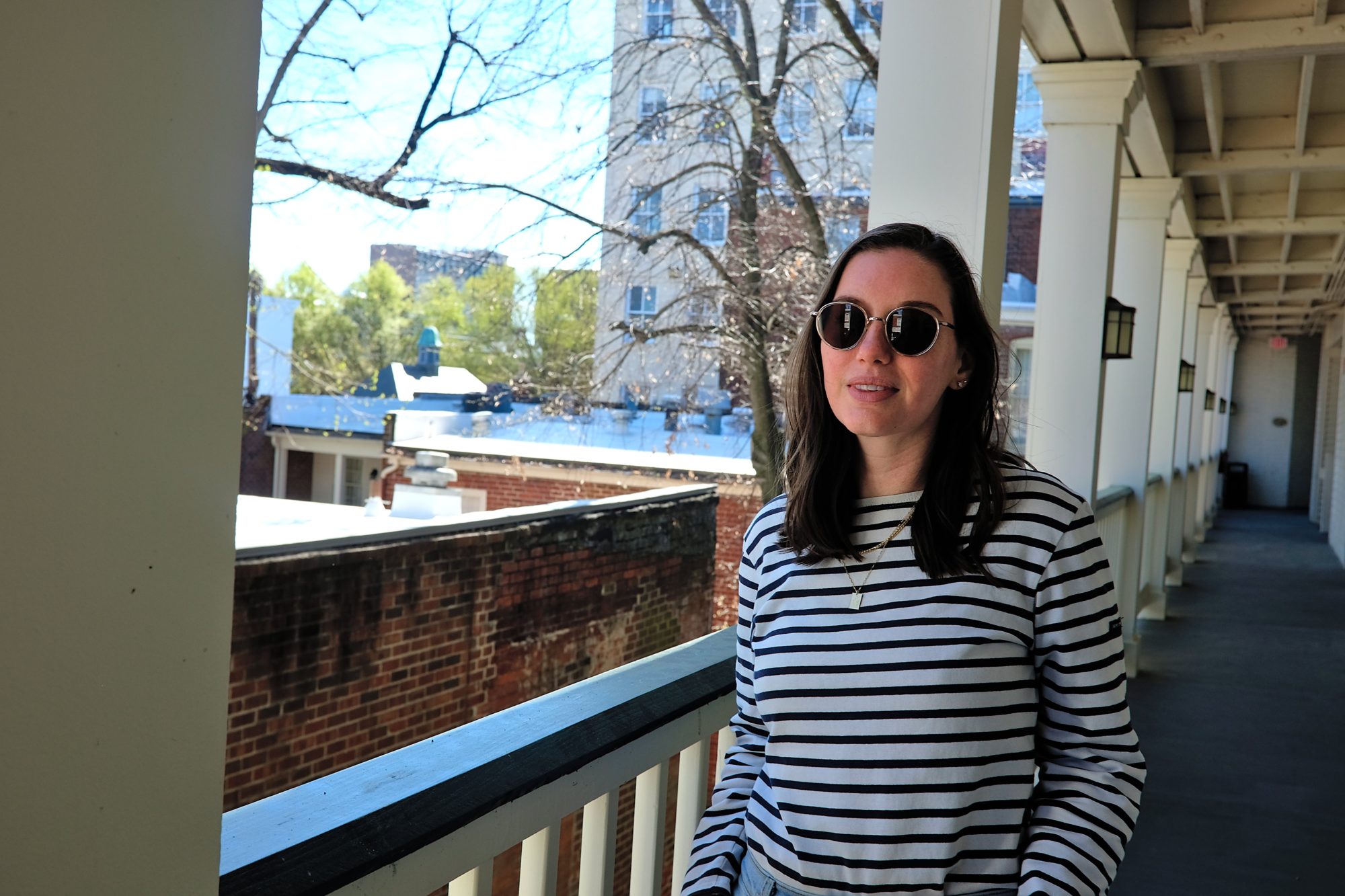 Alyssa stands on the balcony at Linden Row Inn