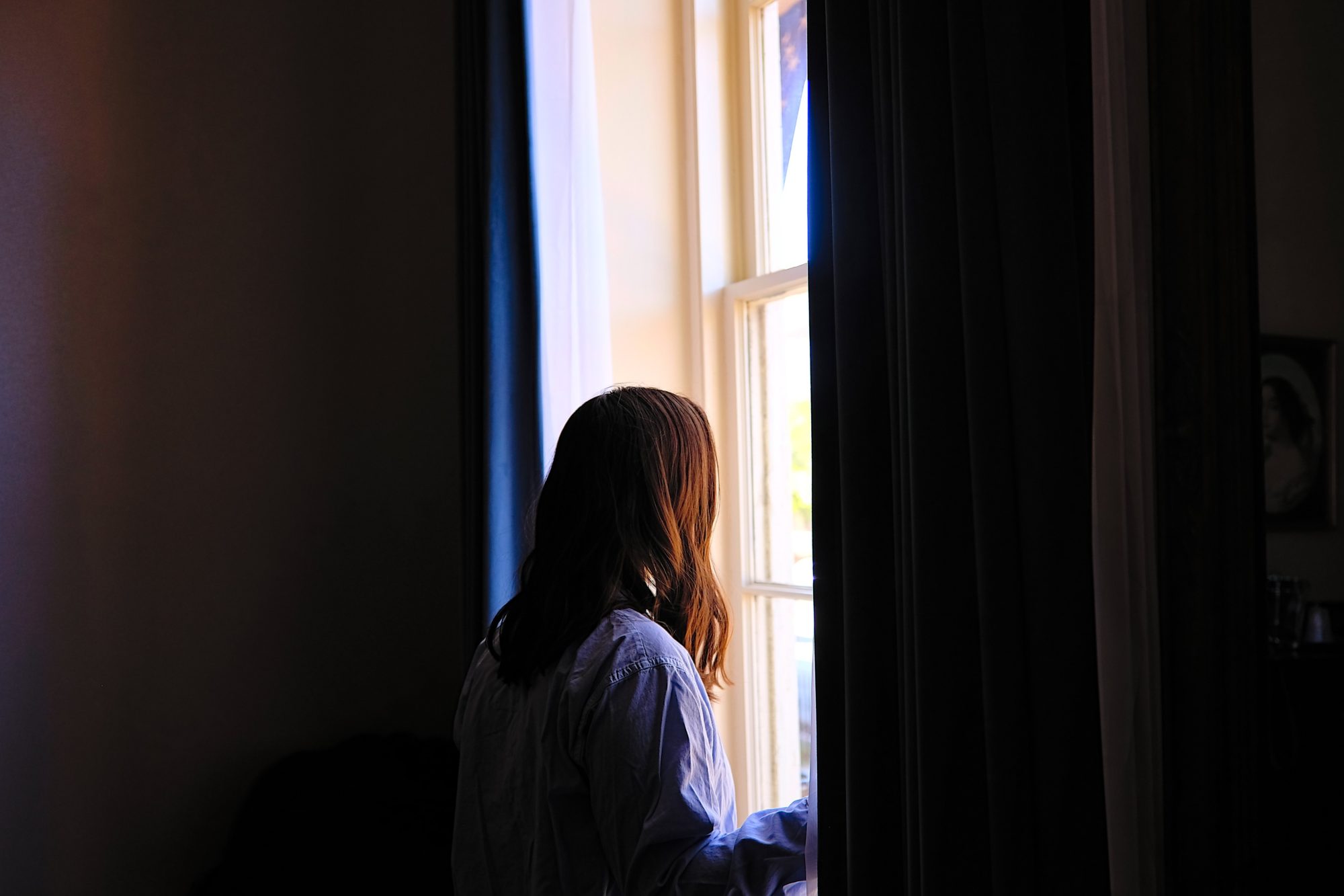 Alyssa peers out the window of Linden Row Inn