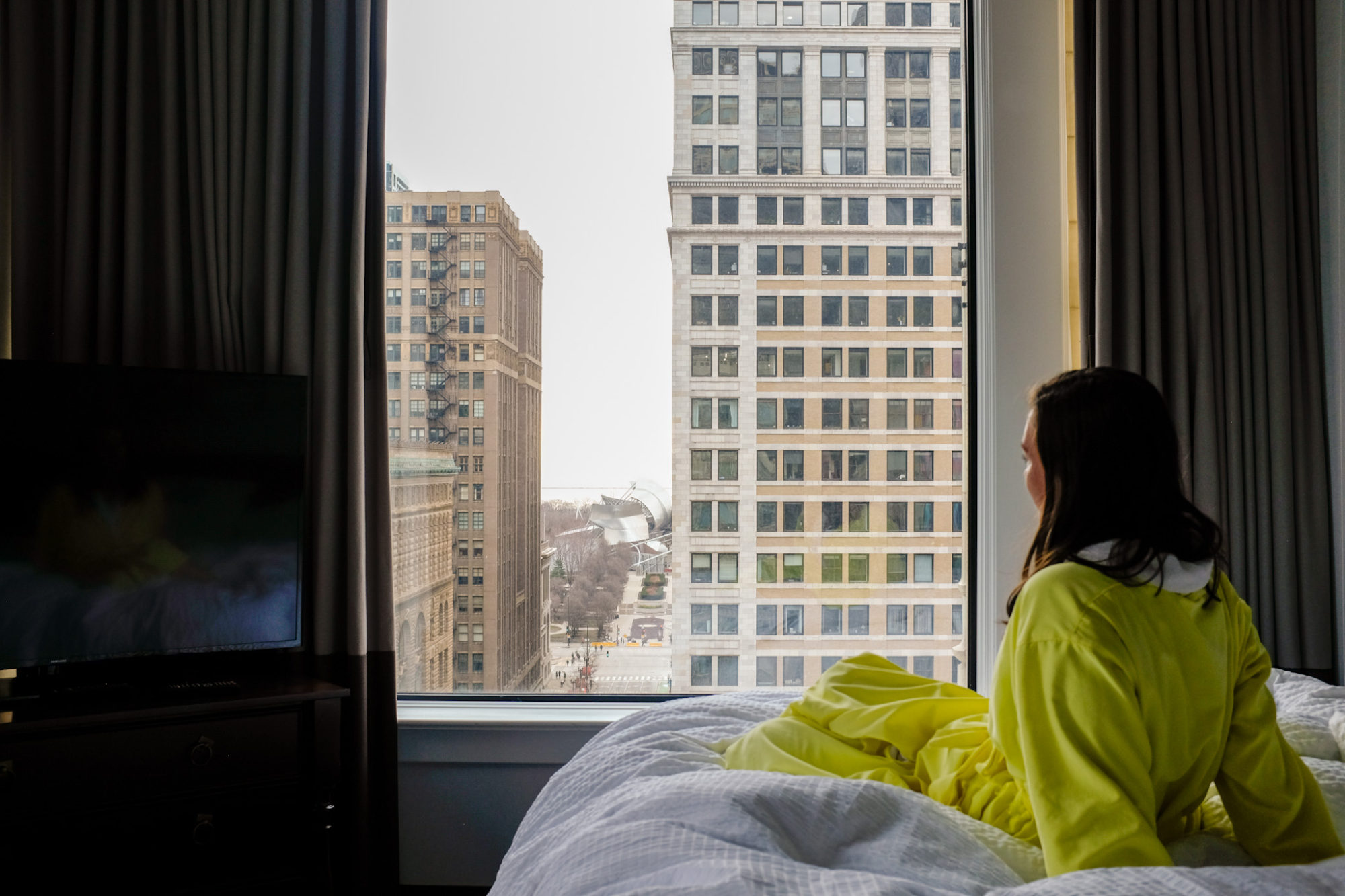 Alyssa looks out the window at Millennium Park