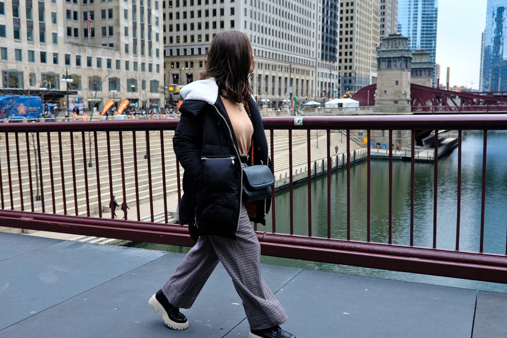 Alyssa walks on a bridge in Chicago