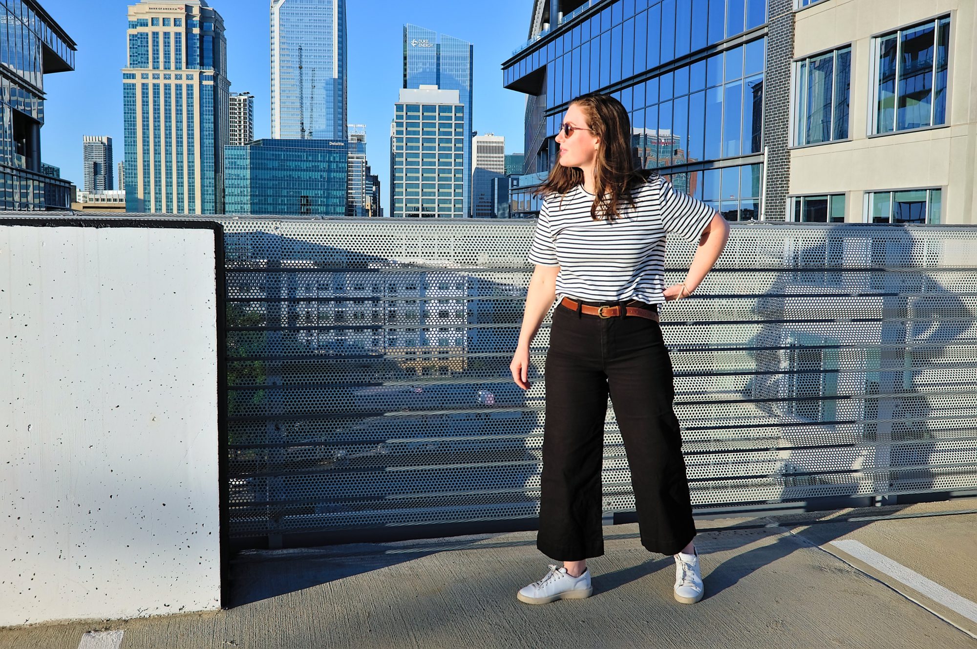 Alyssa wears a tee from ABLE and is in a parking deck