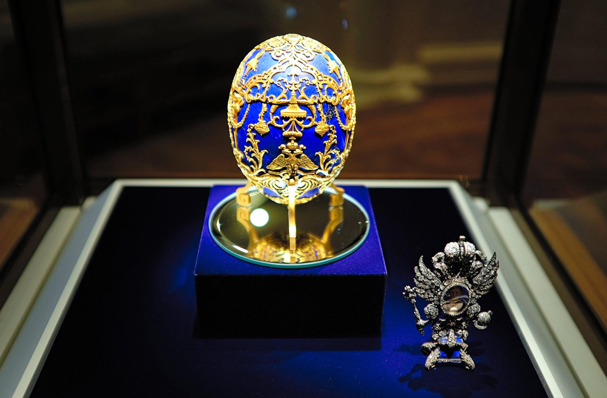 A blue Fabergé egg in a case