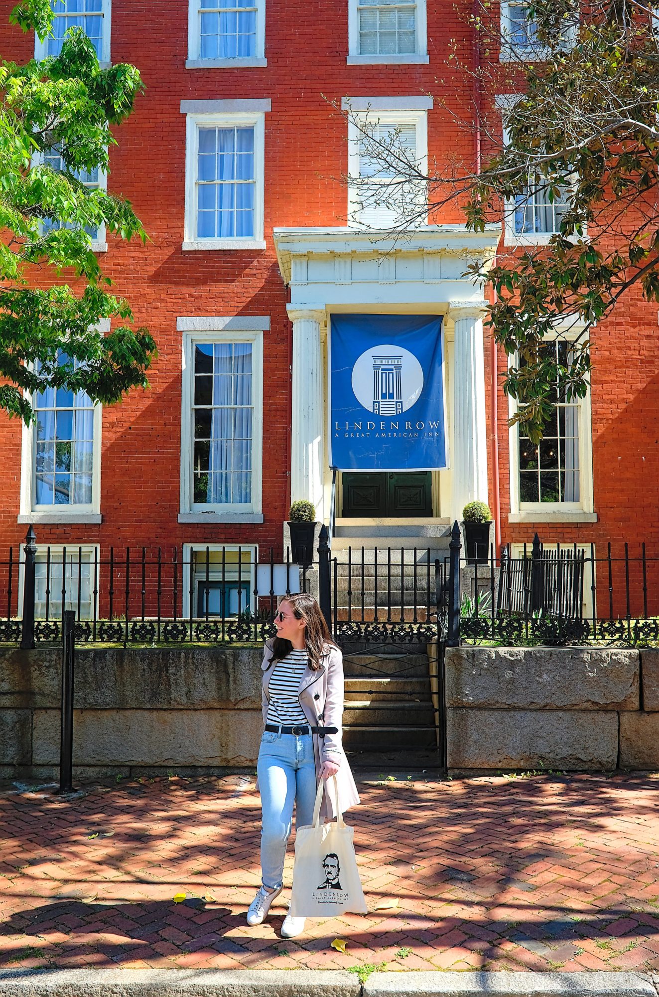 Alyssa walks in front of Linden Row Inn