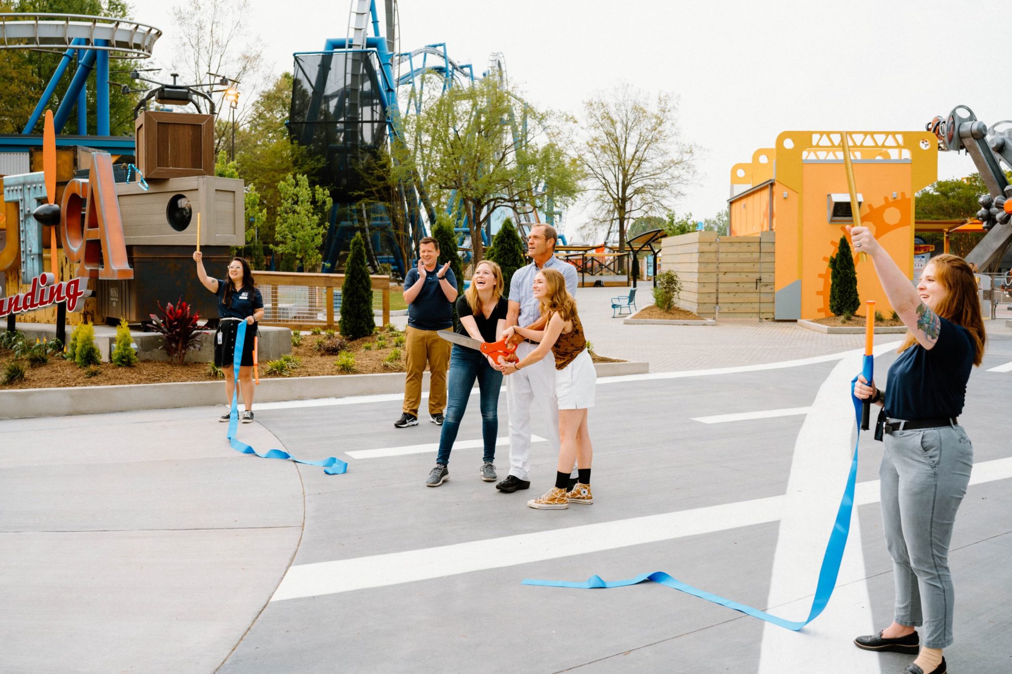 A ribbon cutting ceremony for Aeronautica Landing at Carowinds