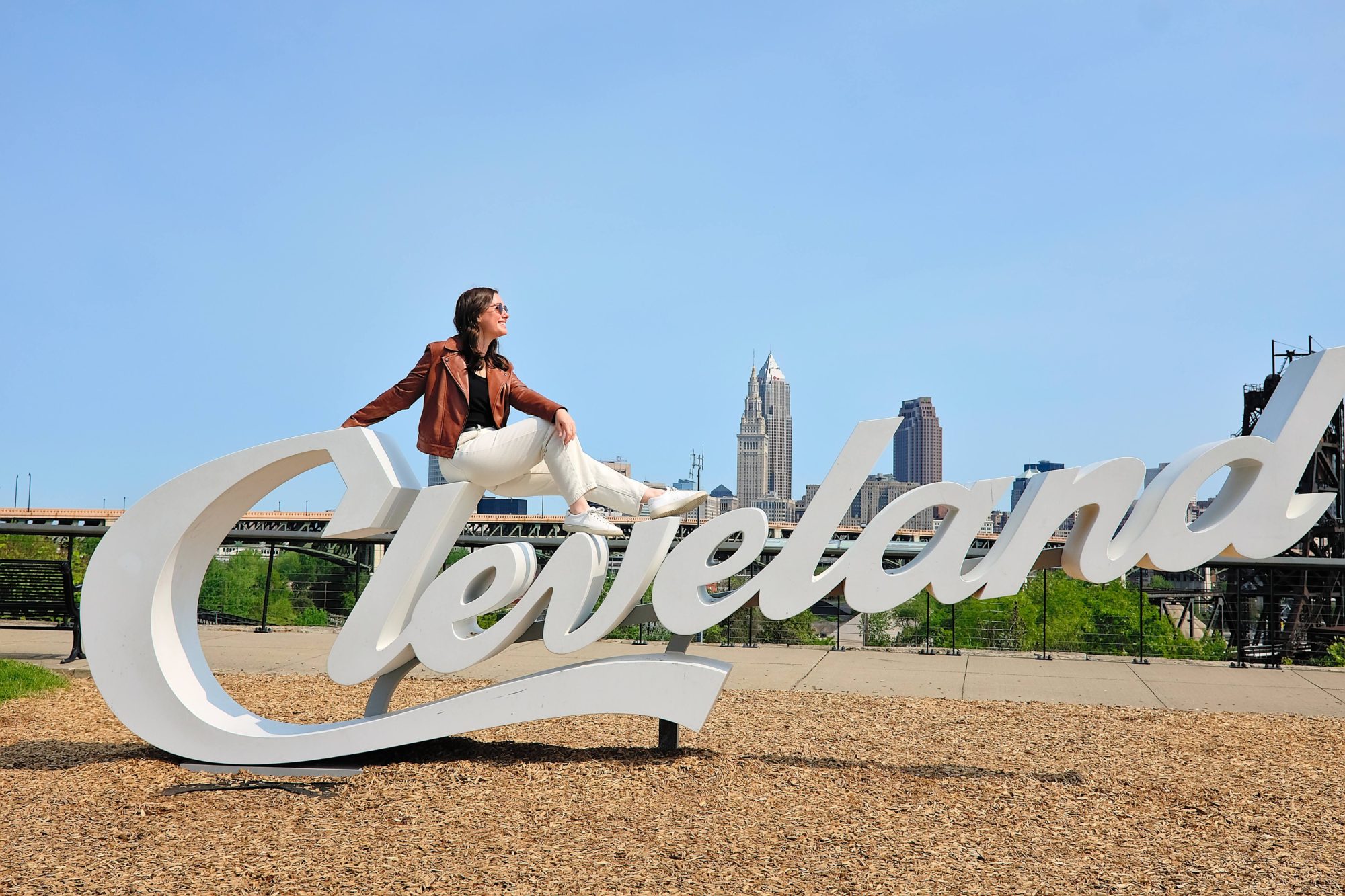 Alyssa sits on a Cleveland sign