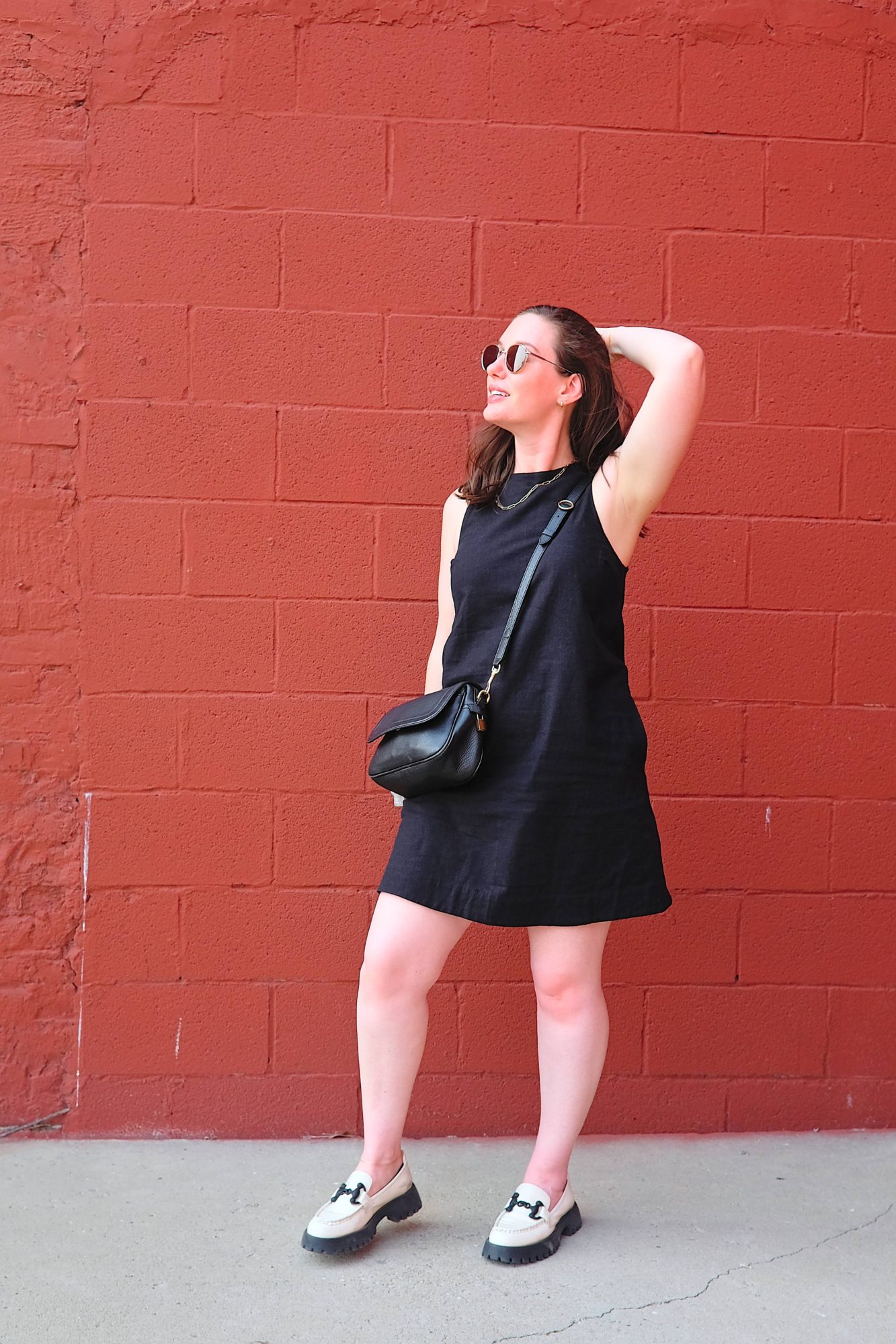 Alyssa stands in front of a tomato sauce colored wall
