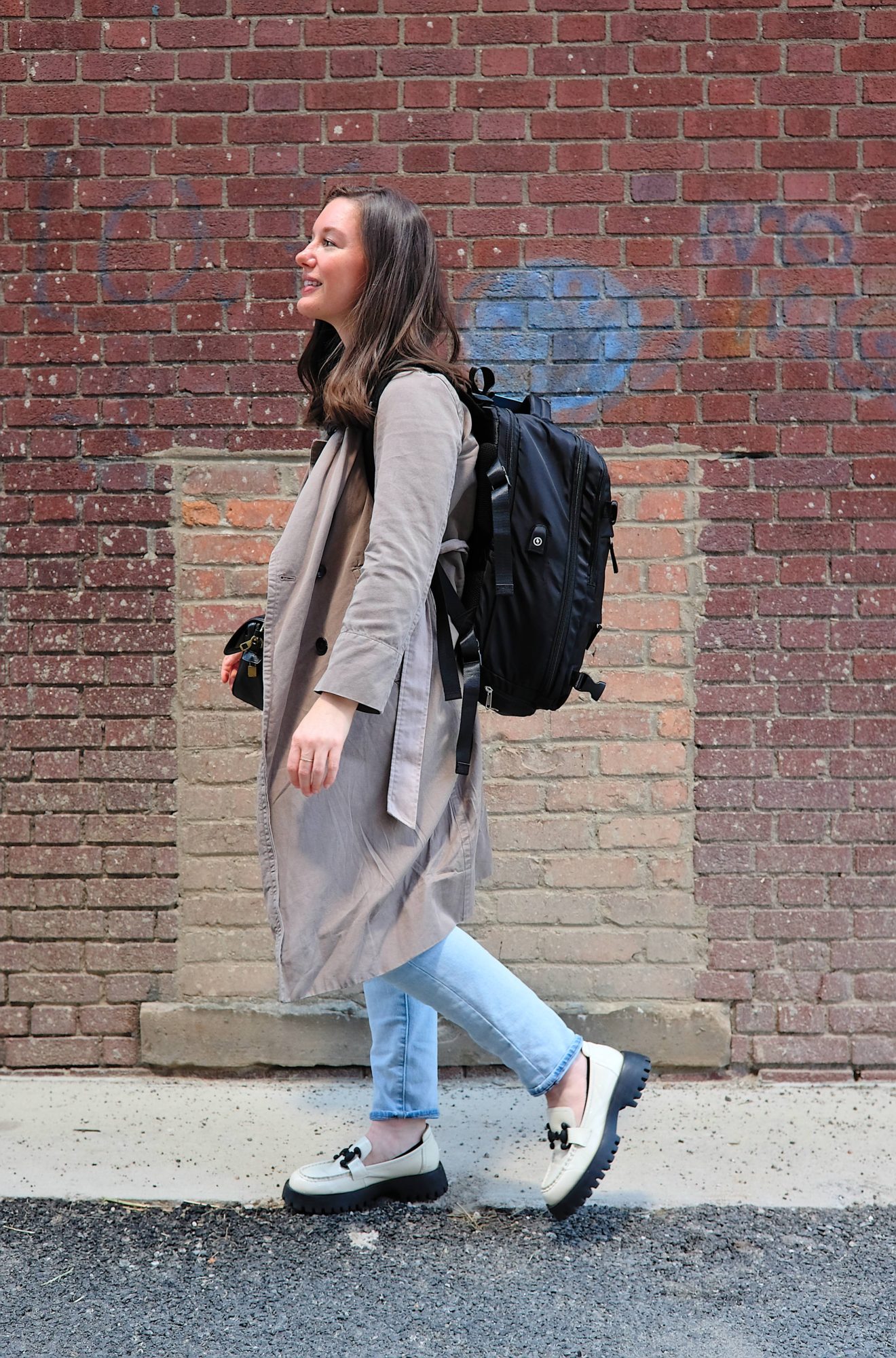 Alyssa walks on a sidewalk in Detroit