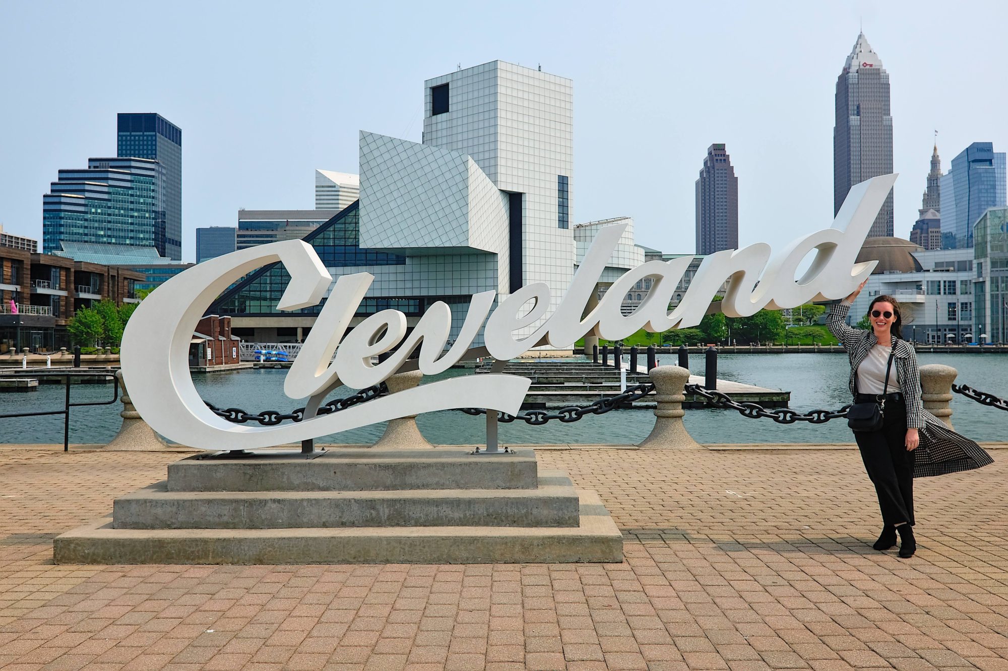 Alyssa stands with the Cleveland Script Sign at North Coast Harbor