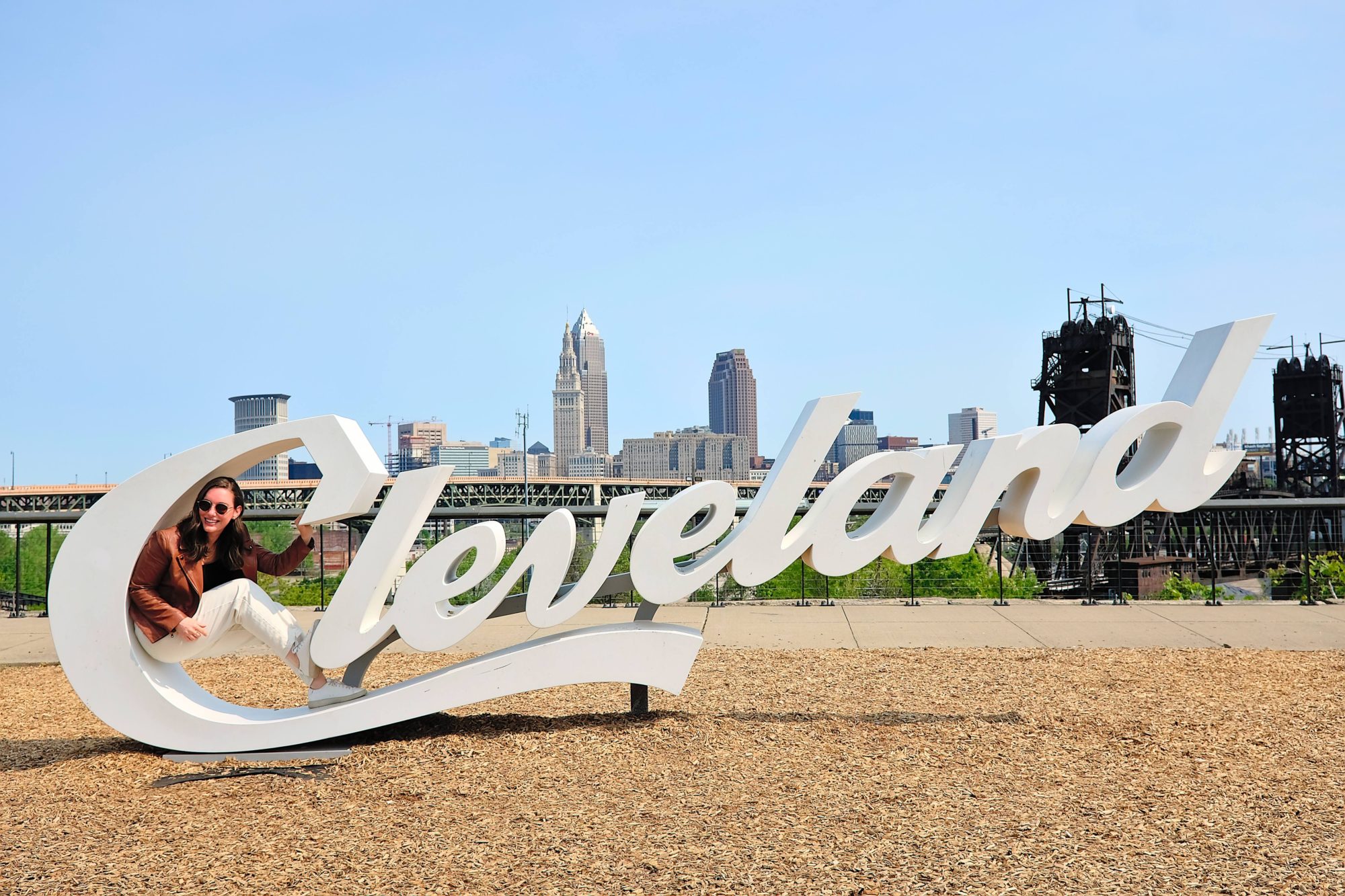 Alyssa in the C of a Cleveland script sign