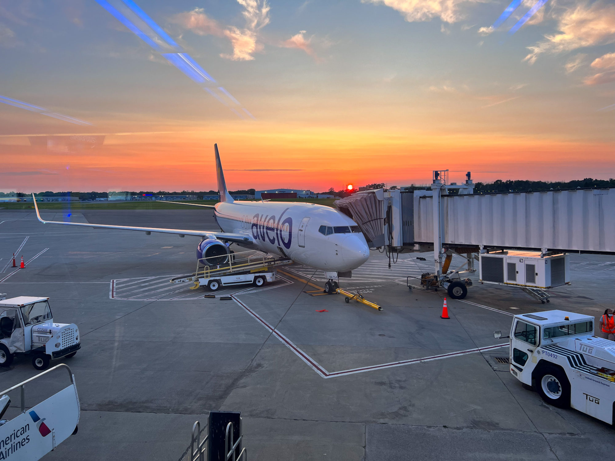 A view of an Avelo airplane at sunset