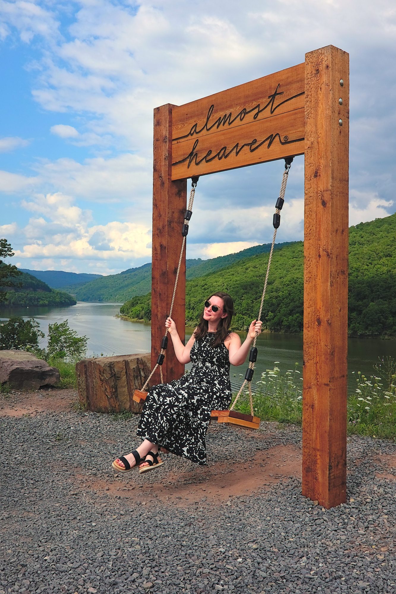 Alyssa swings on an Almost Heaven swing at Bluestone Lake
