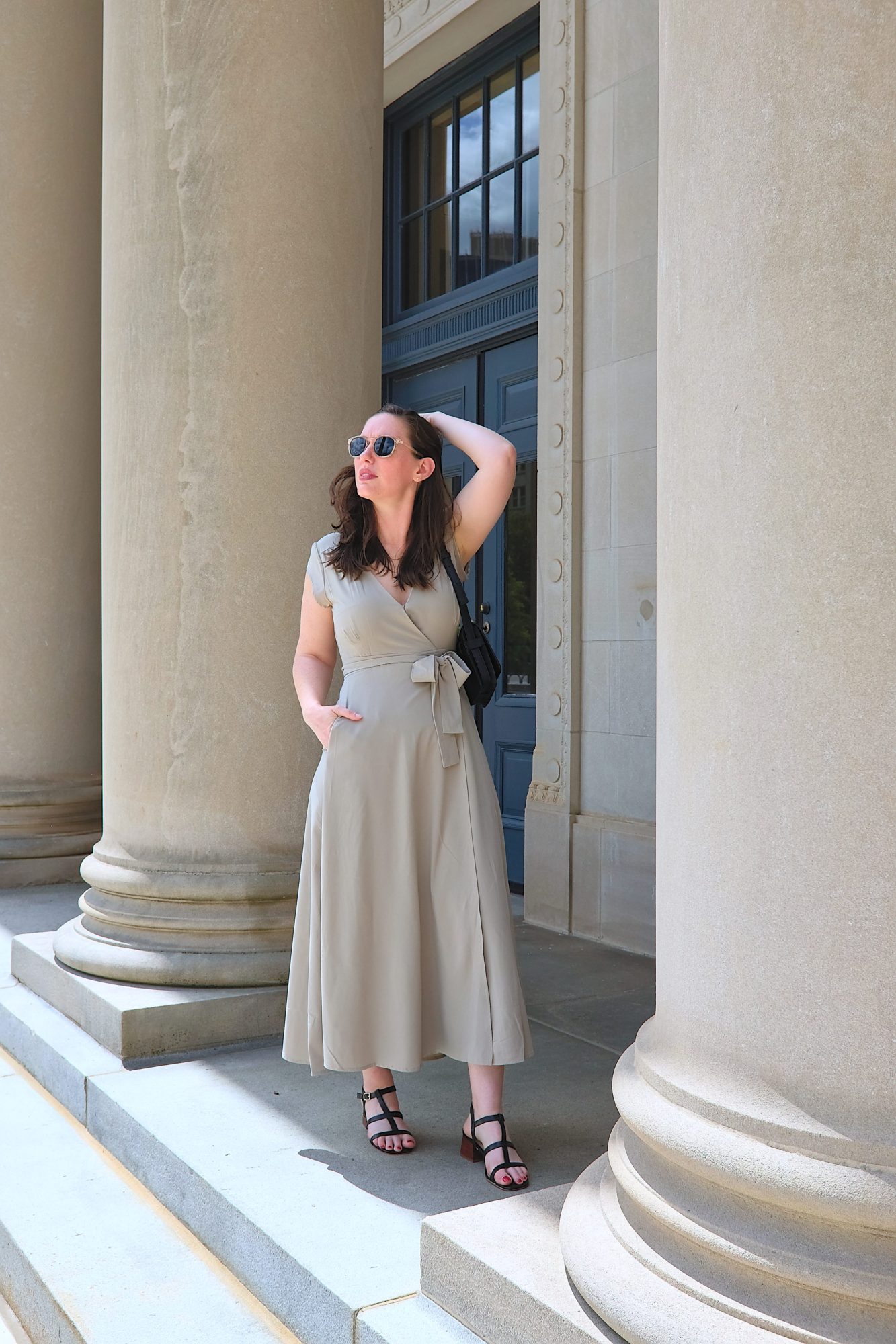 Alyssa wears the Roma dress with black heeled sandals and sunglasses