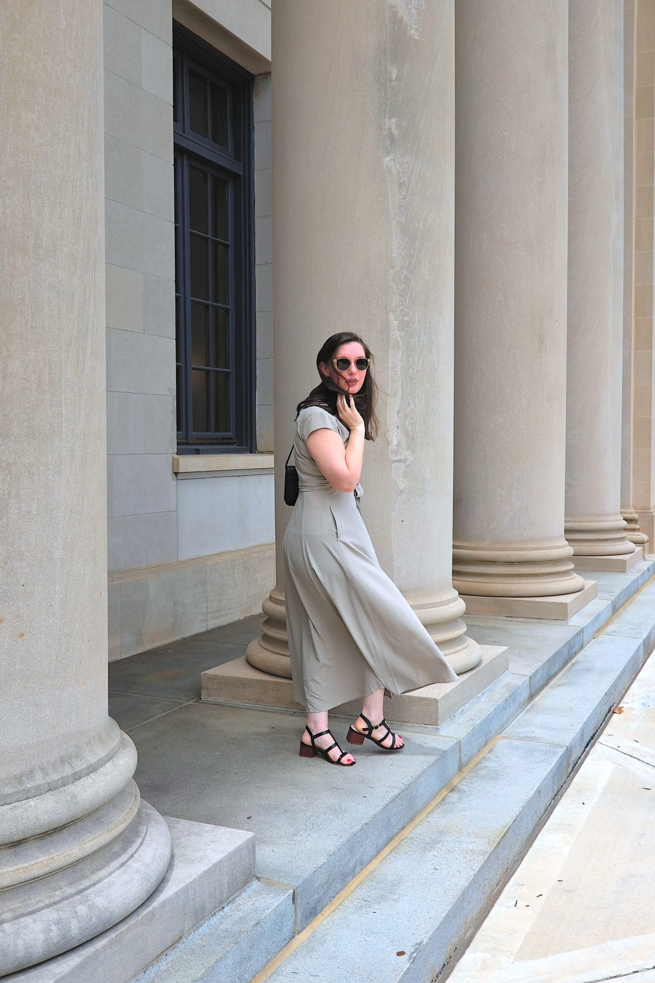 Alyssa wears the grey dress from wayre and walks away from the camera