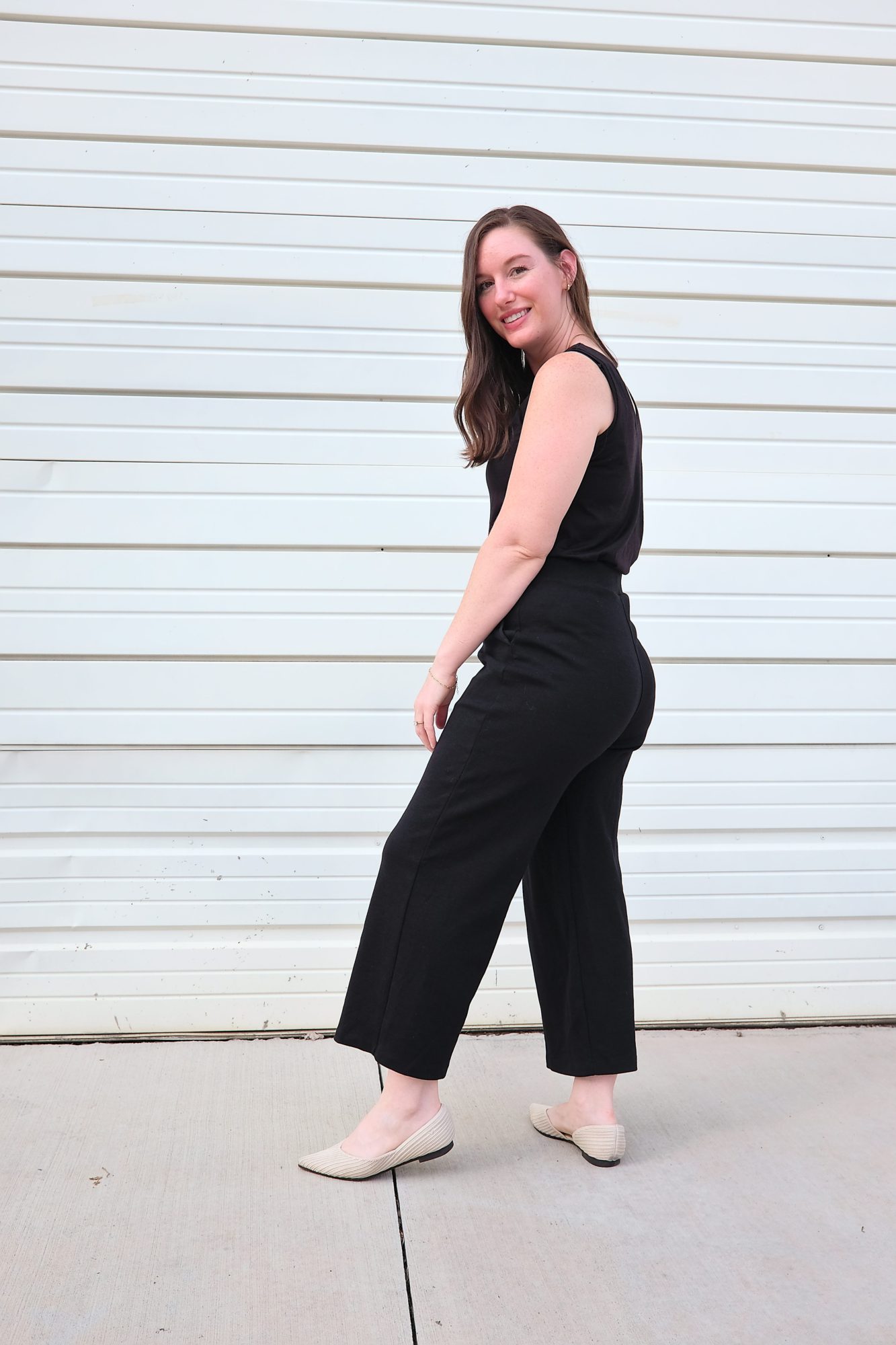 Alyssa wears the Frame Ponte Culotte with the Poppy Tank and turns in profile