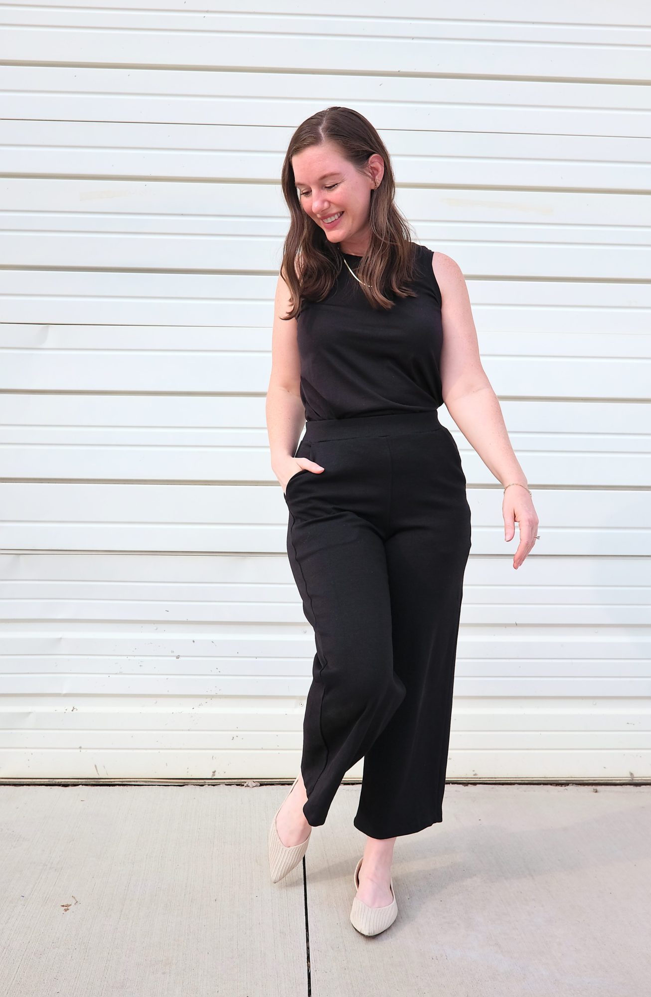Alyssa wears the Frame Ponte Culotte with the Poppy Tank and looks downward