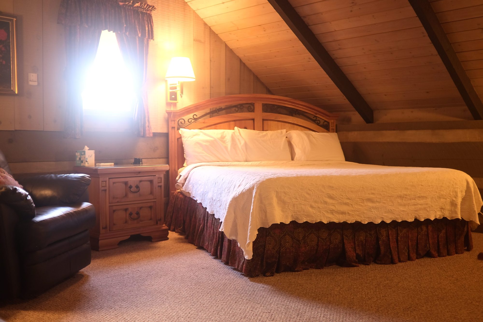 A loft bedroom with king bed and other furniture