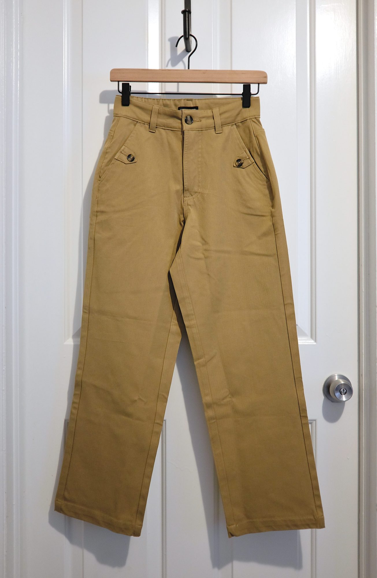 The Casual Stretch Twill Pants hang on a hanger