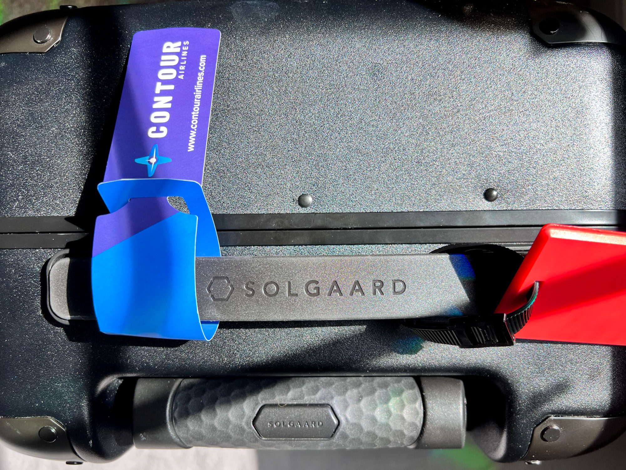 A Solgaard suitcase with a Contour tag