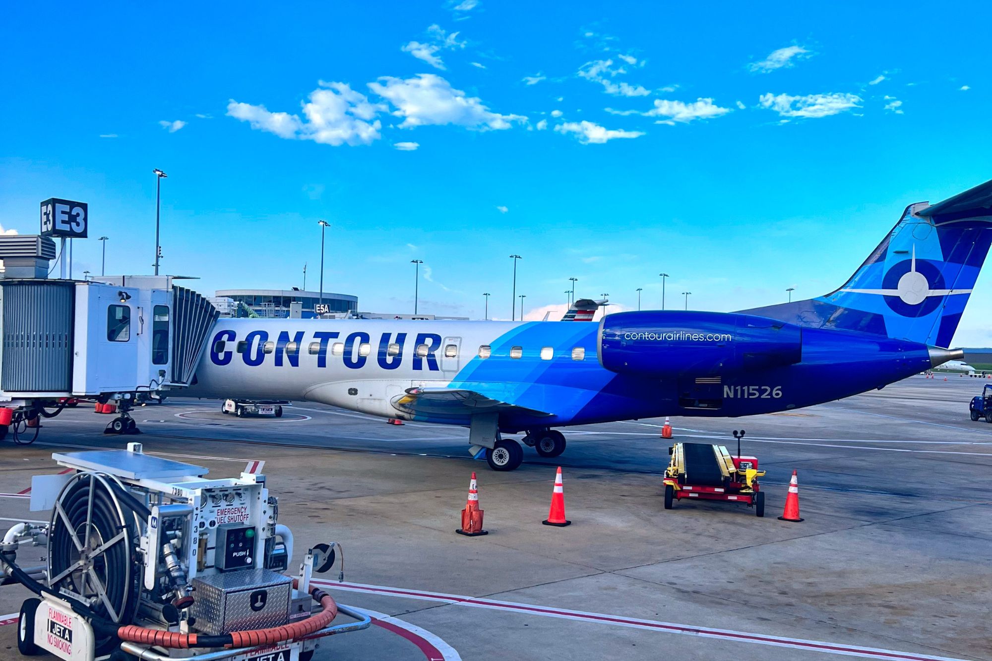A Contour Airlines plane at a gate