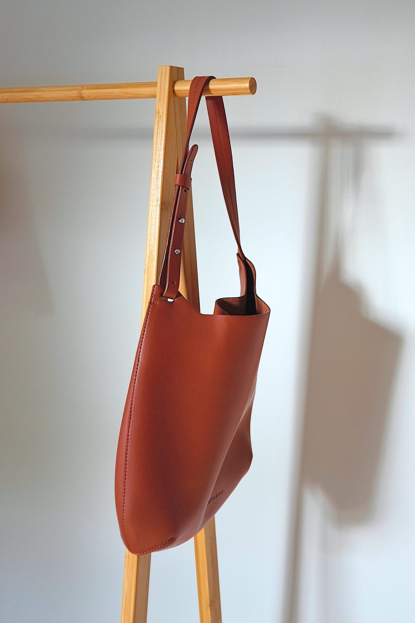 The Cactus Leather Hobo hangs on a clothing rack