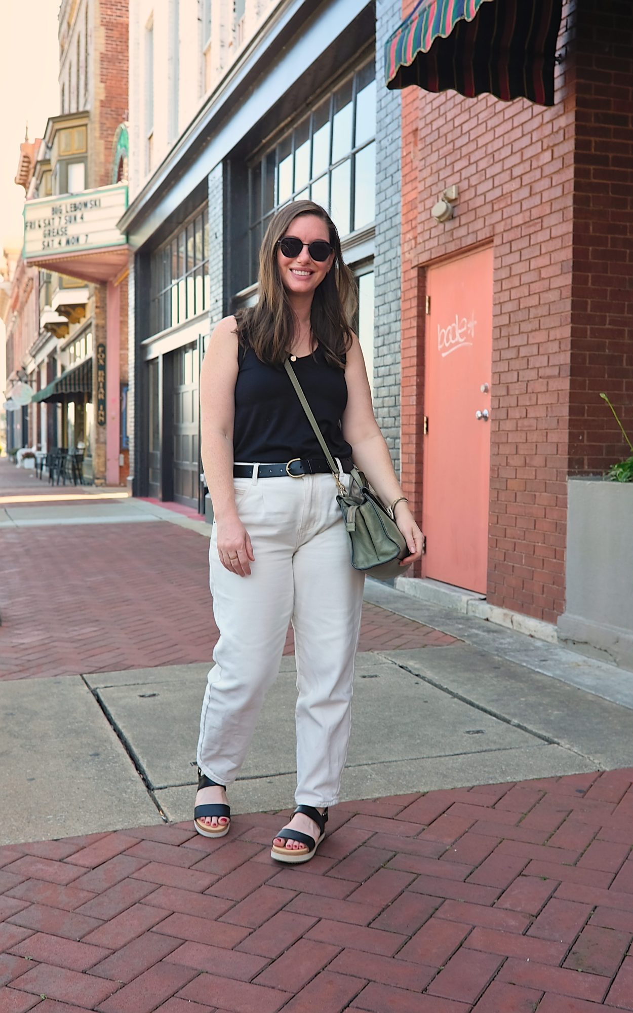 Alyssa wears a black tank with white denim and sandals in Paducah