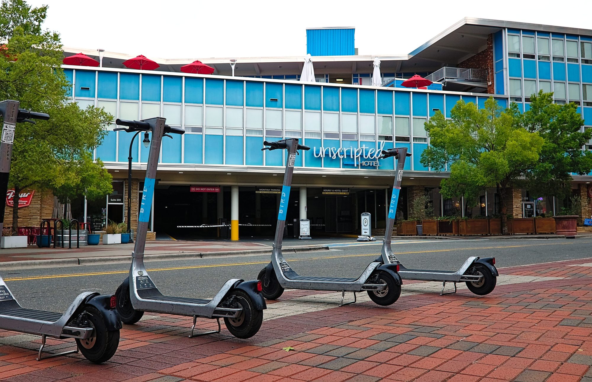 A row of scooters in front of Unscripted Durham