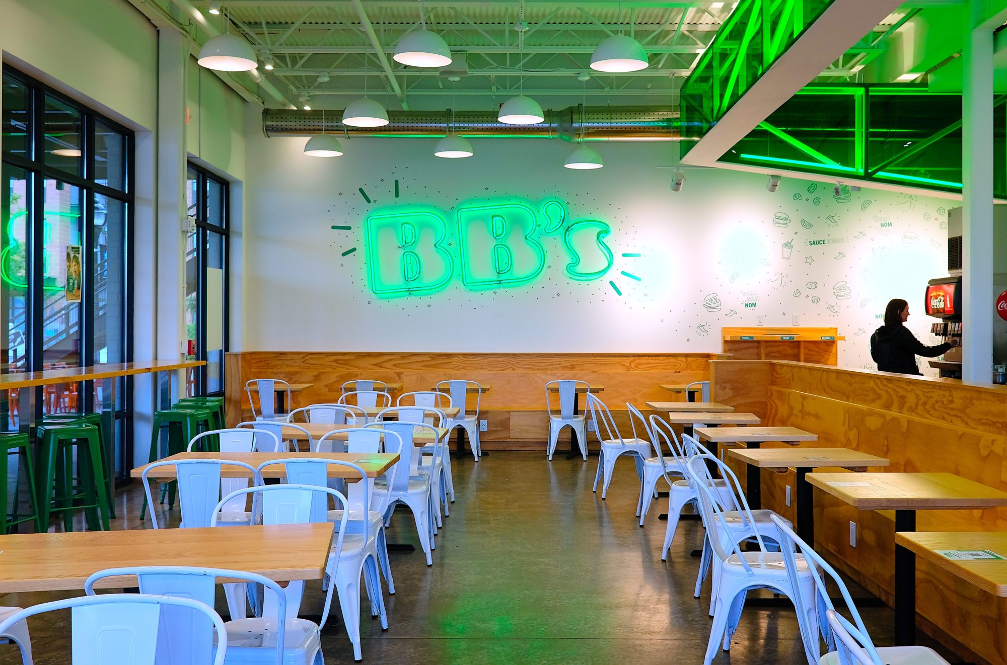 Interior of BB's Crispy Chicken, with a large green neon sign