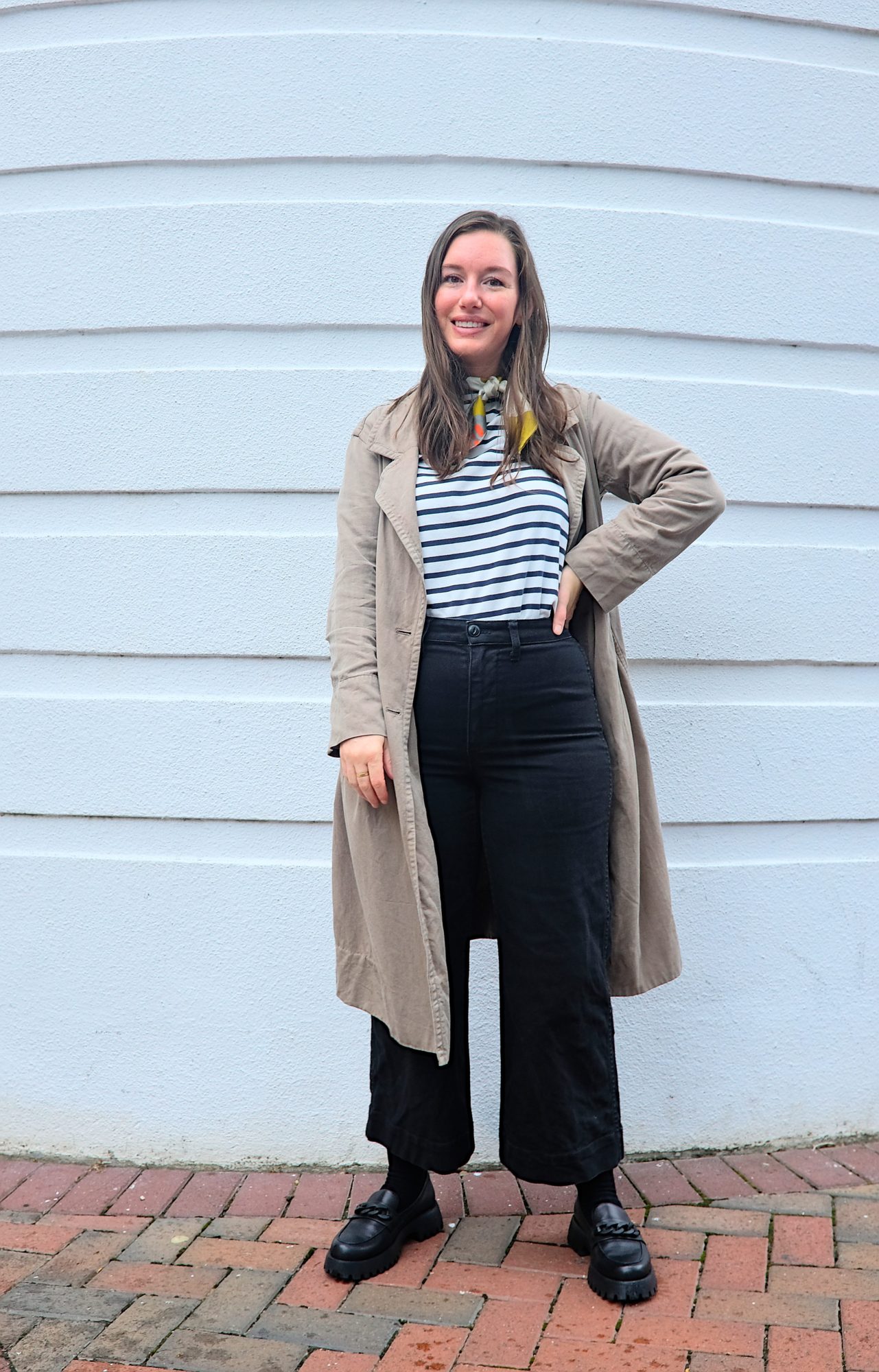 Alyssa wears a Breton top with wide leg pants and loafers