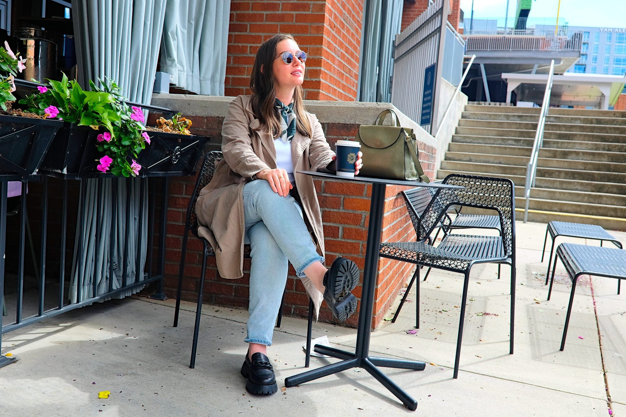 Alyssa sits at a table outside of Press