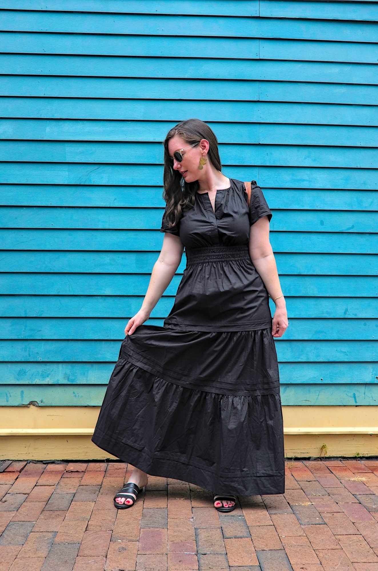 Alyssa wears the Quince Cotton Tiered Maxi Dress with sandals and a basket purse