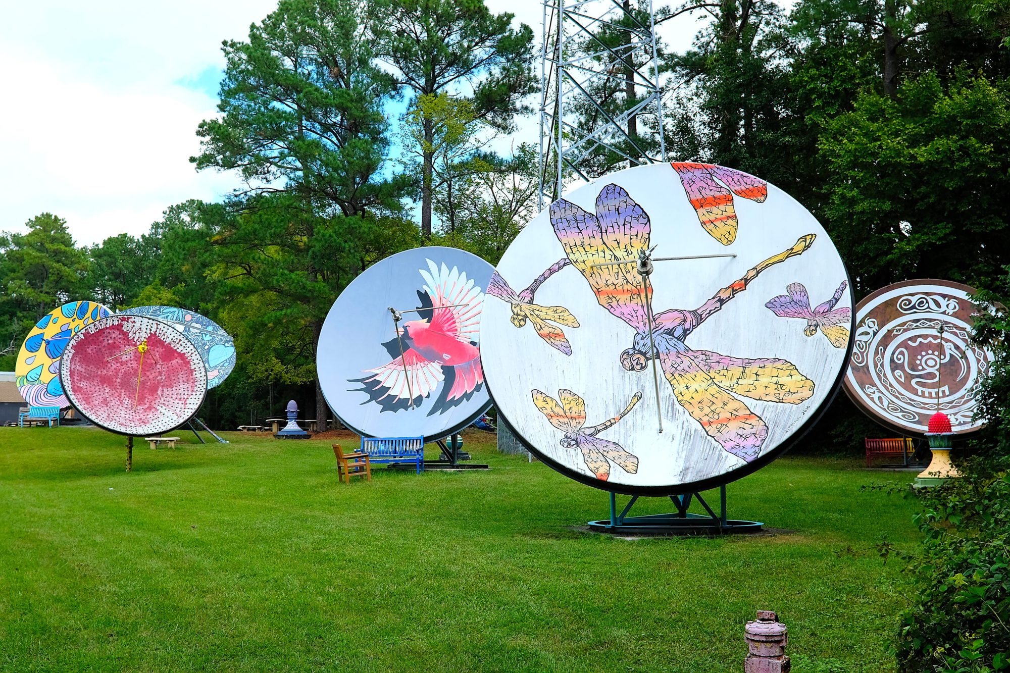 A collection of satellite dishes with murals