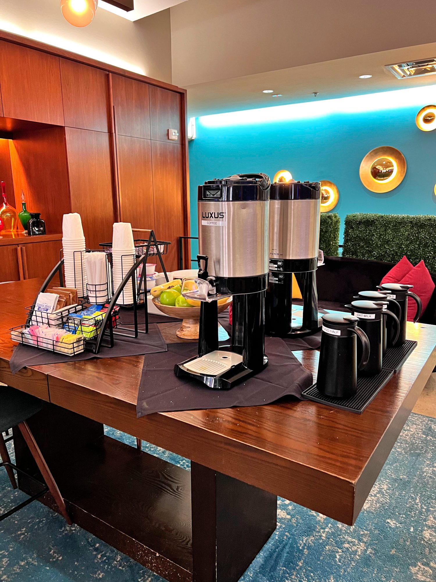 A table is set with coffee and grab-and-go breakfast items