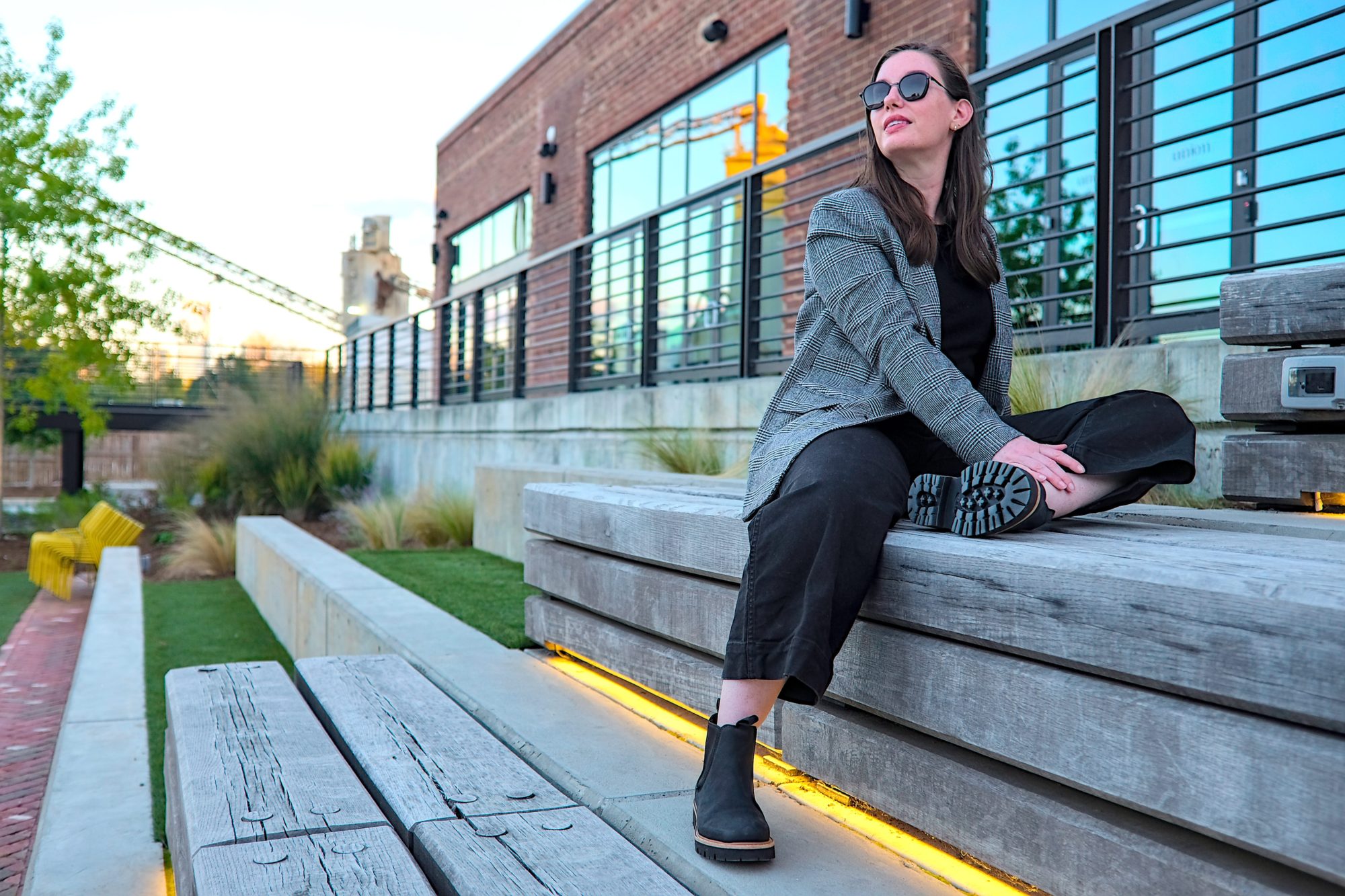 Alyssa sits and wears the Go-To Lug Chelsea Boots