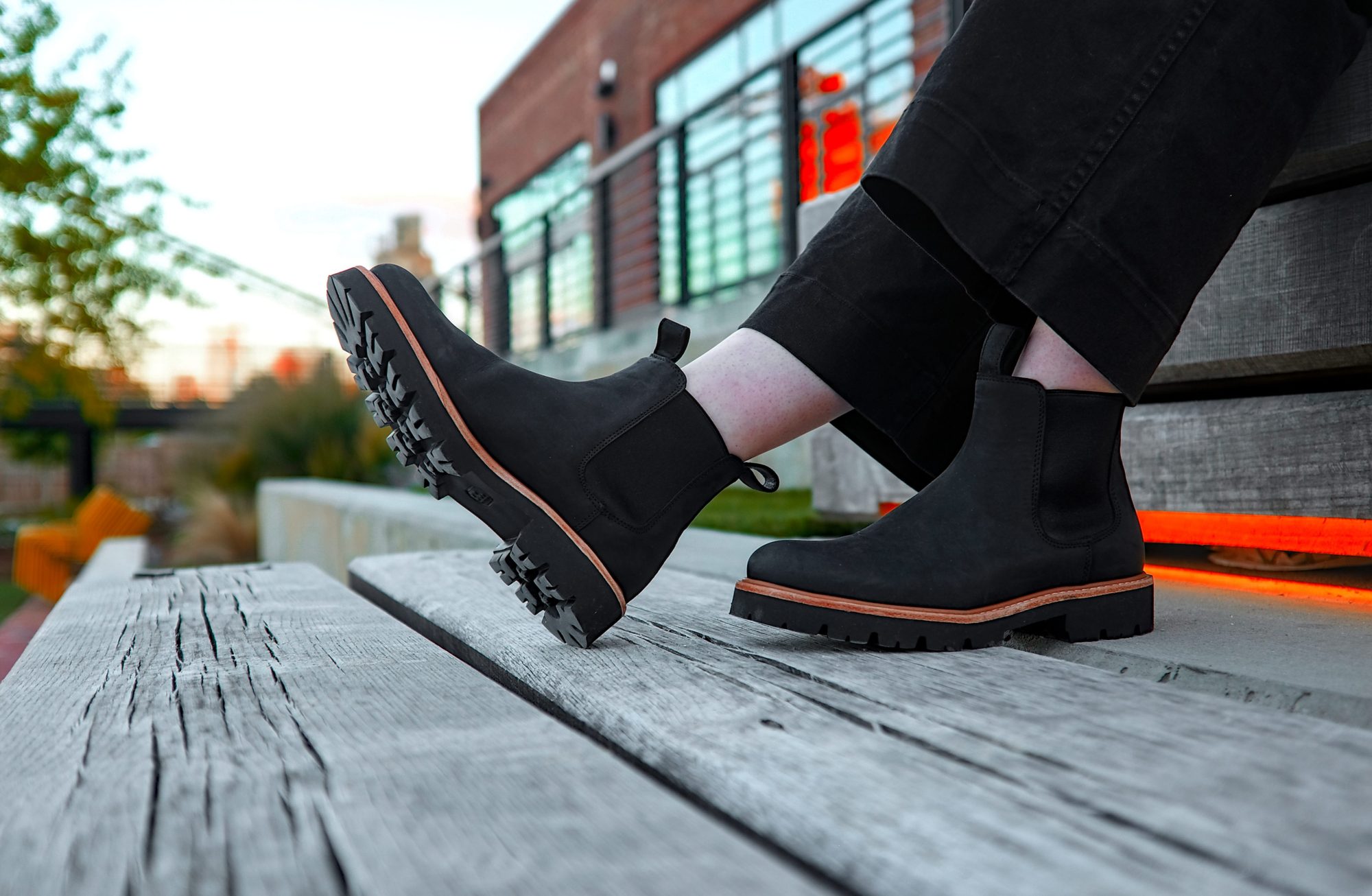 Alyssa sits and wears the Nisolo boots in a closeup shot