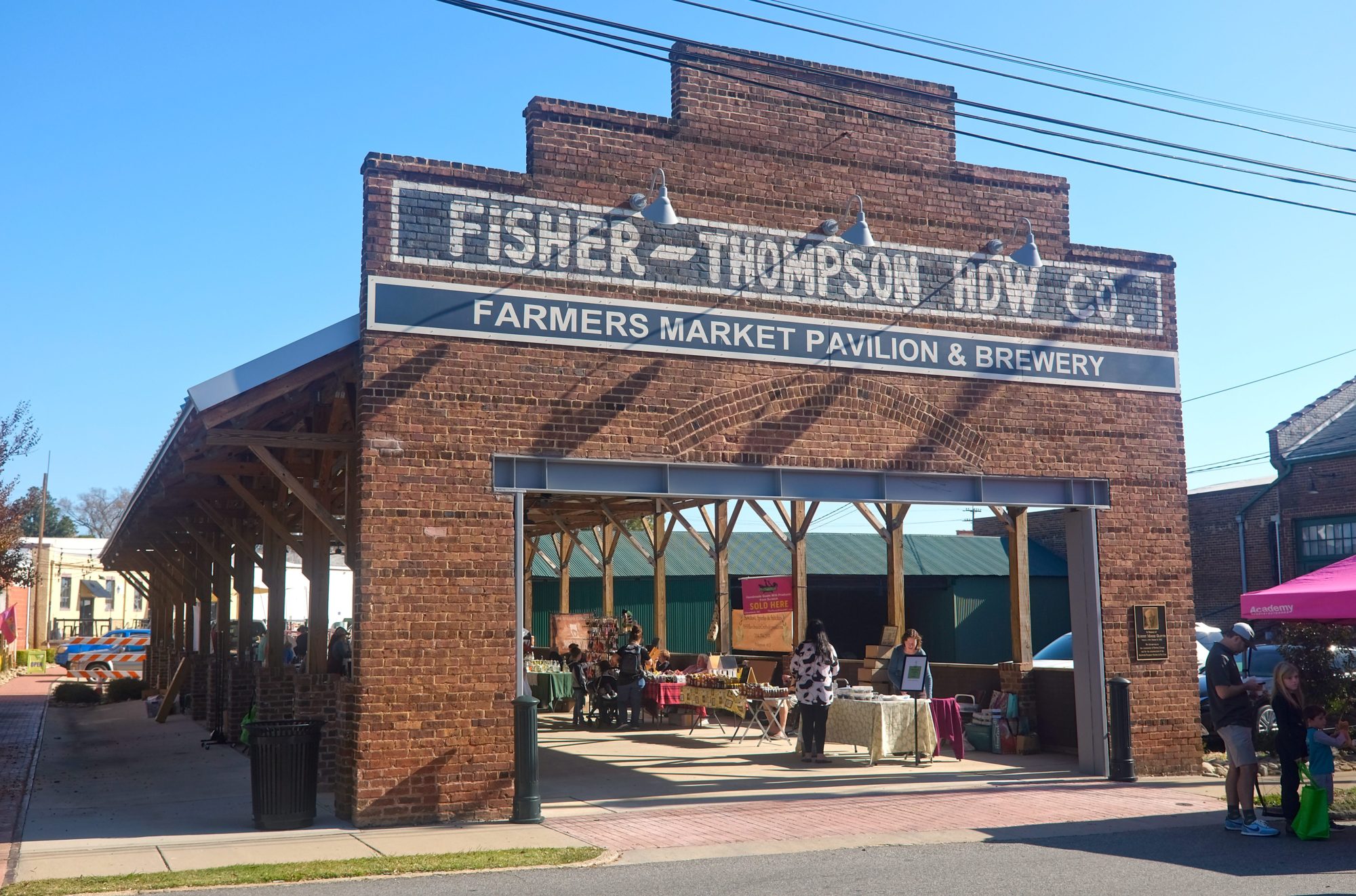 Exterior of the farmers market in downtown Salisbury, North Carolina, with shoppers and vendors