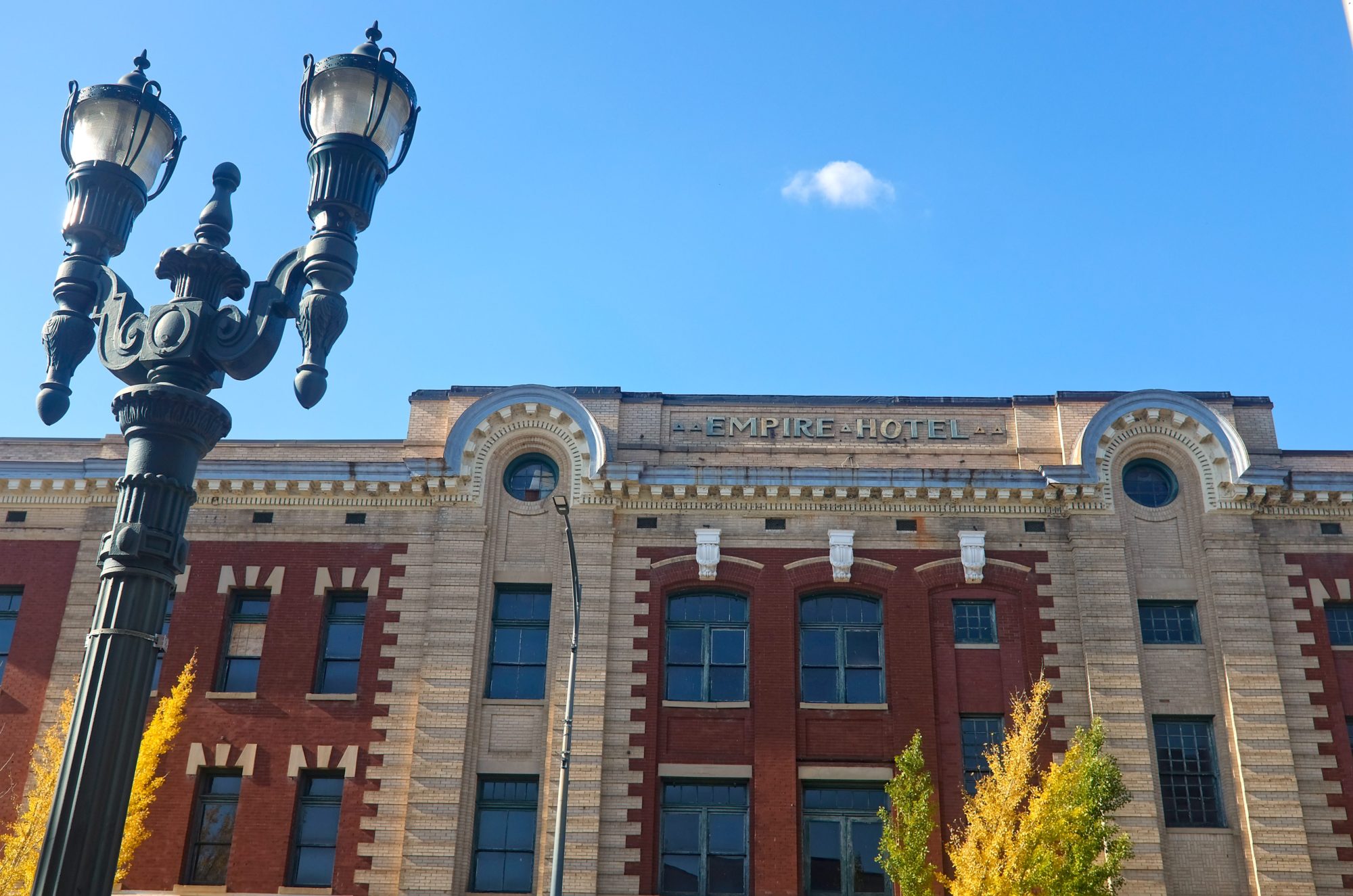 Exterior of old building that reads "Empire Hotel"