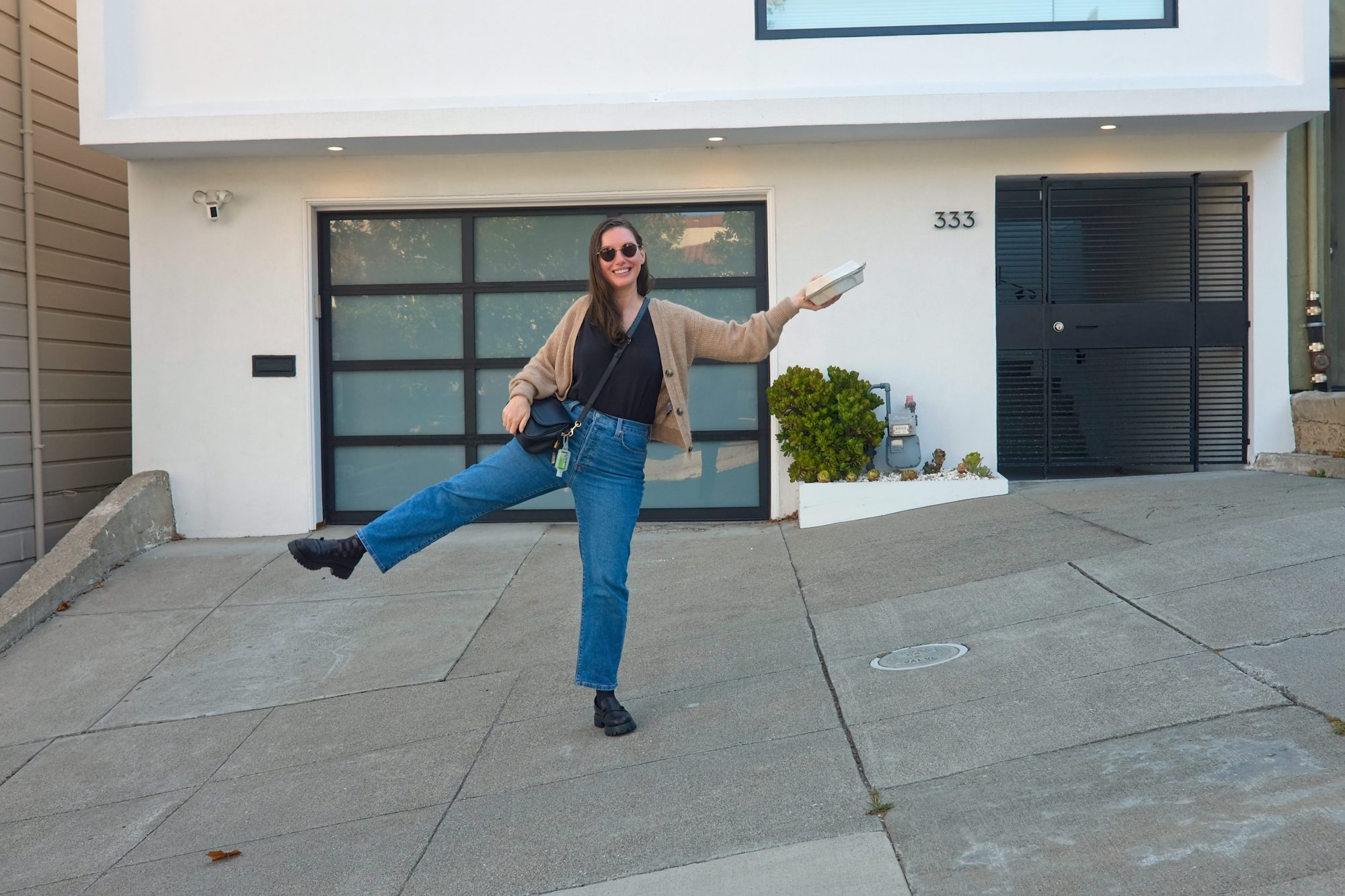 Alyssa holds a takeout box on a steep street in San Francisco