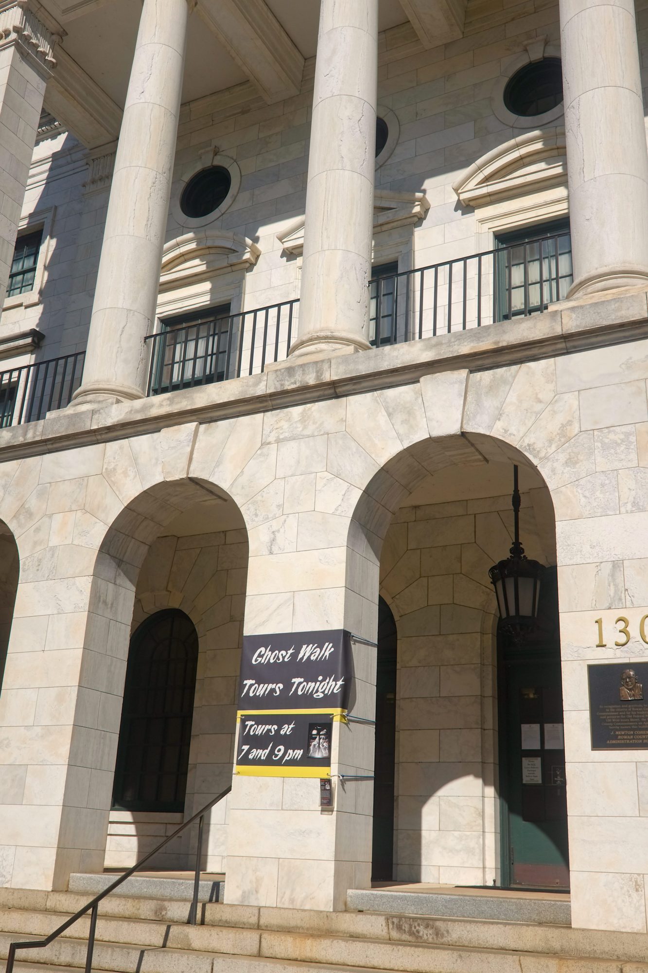 Exterior of a building with a sign advertising Salisbury Ghost Walks