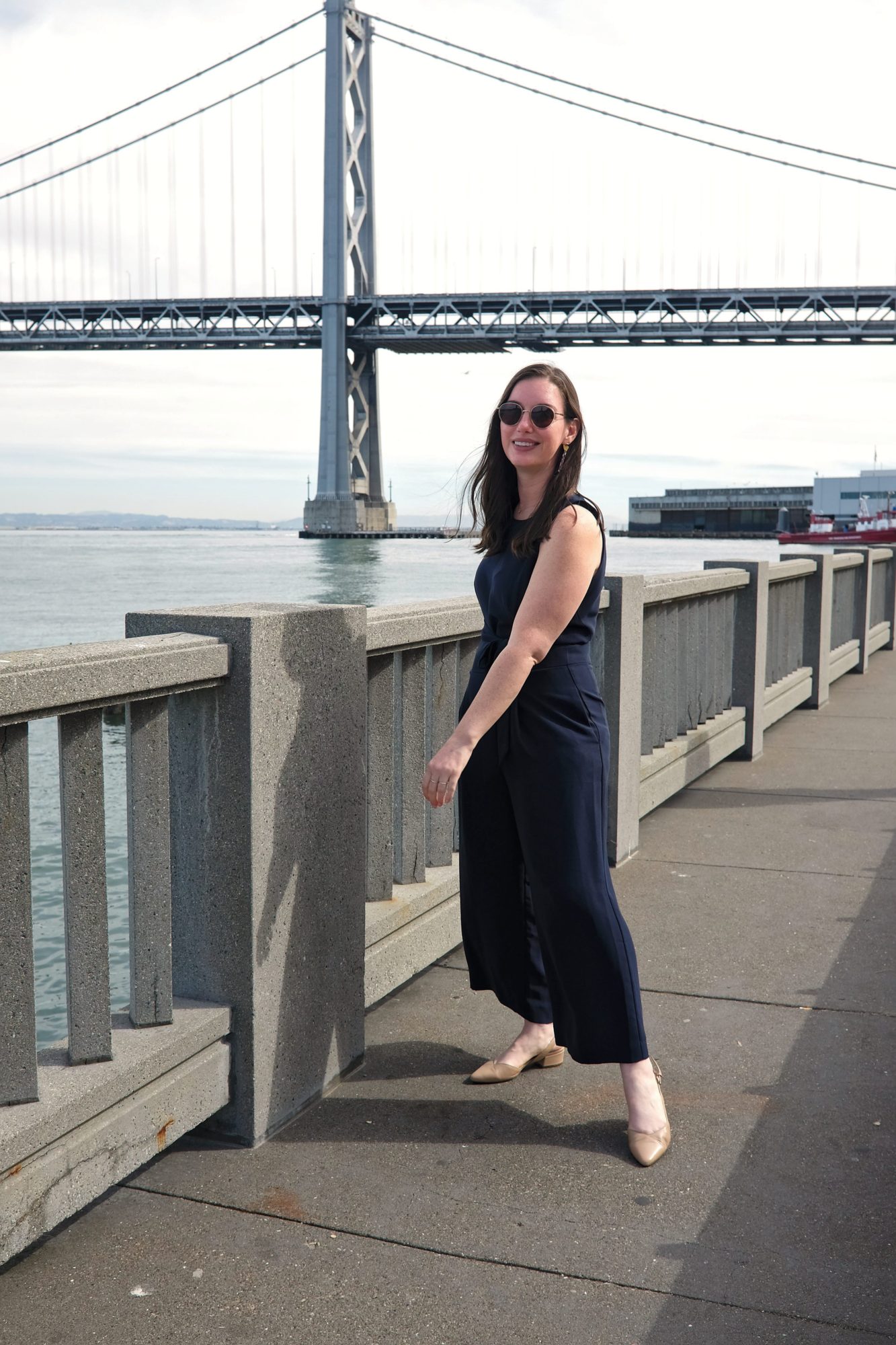 Alyssa stands in front of a bridge in San Francisco