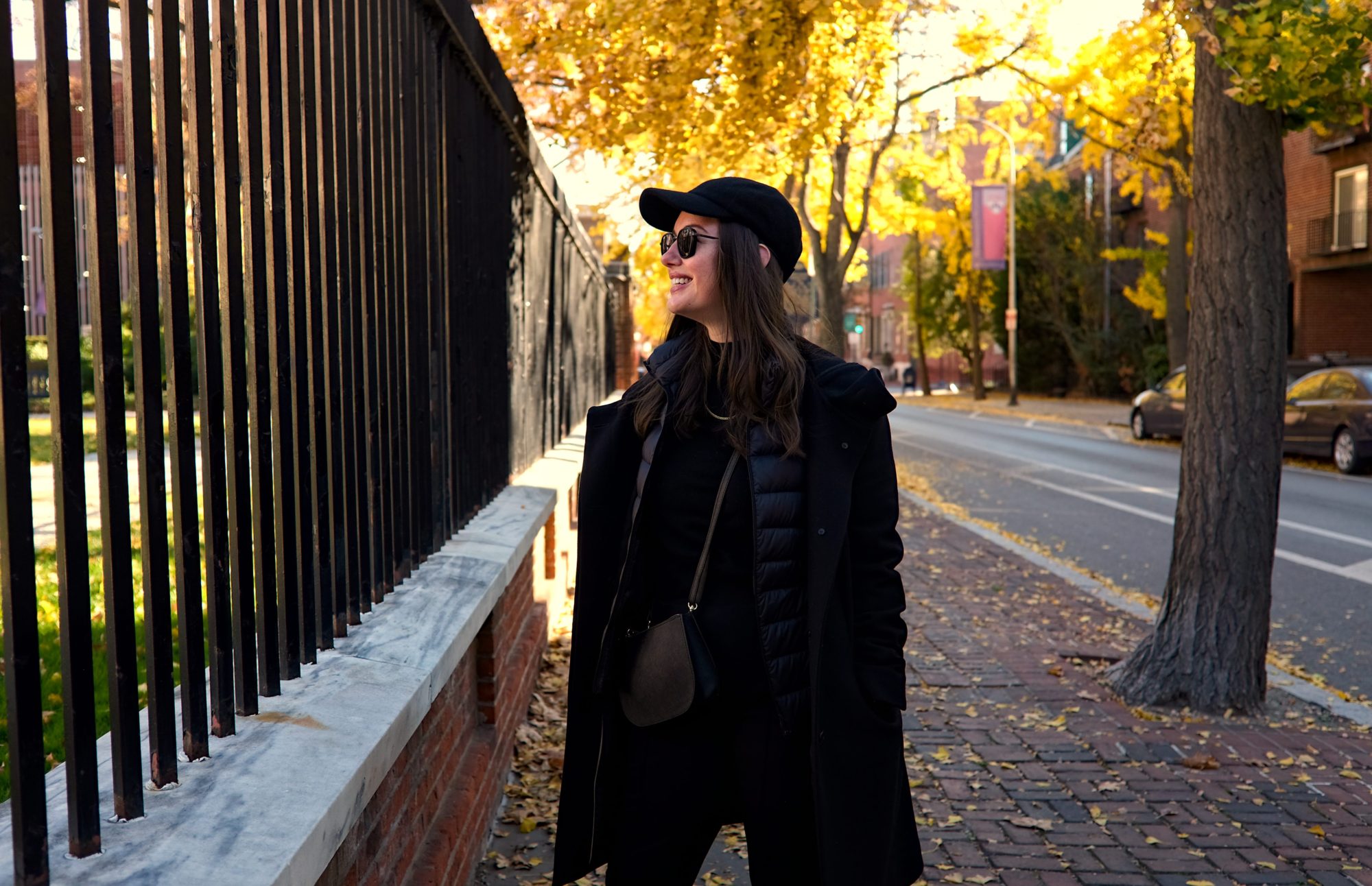 Alyssa stands on a sidewalk in Philadelphia, looking away from the camera