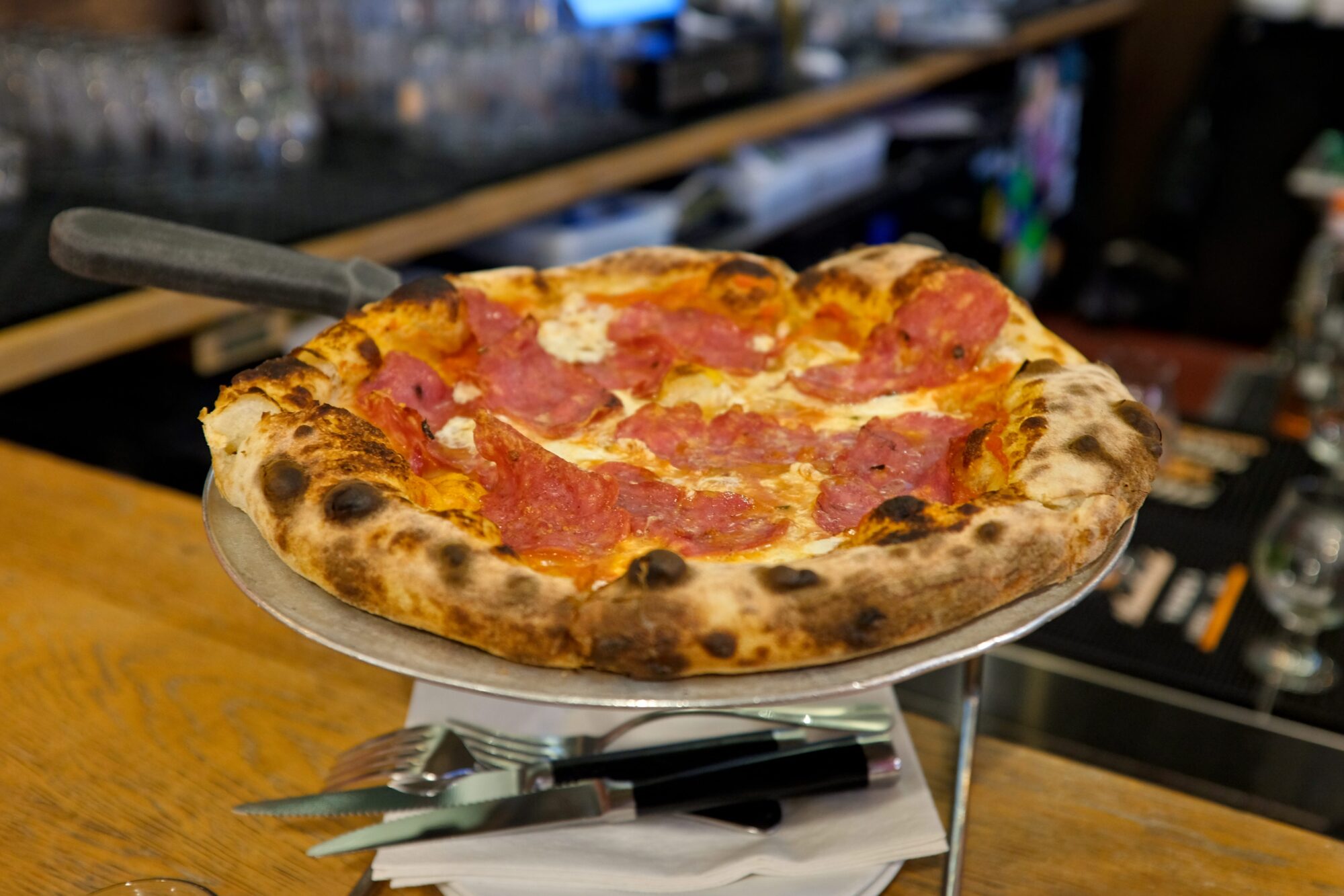 A pizza with cured meats at Area Four in Cambridge