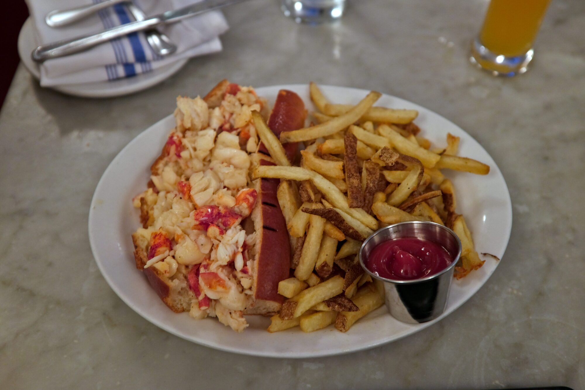 A plate with lobster roll and fries from Neptune Oyster in Boston