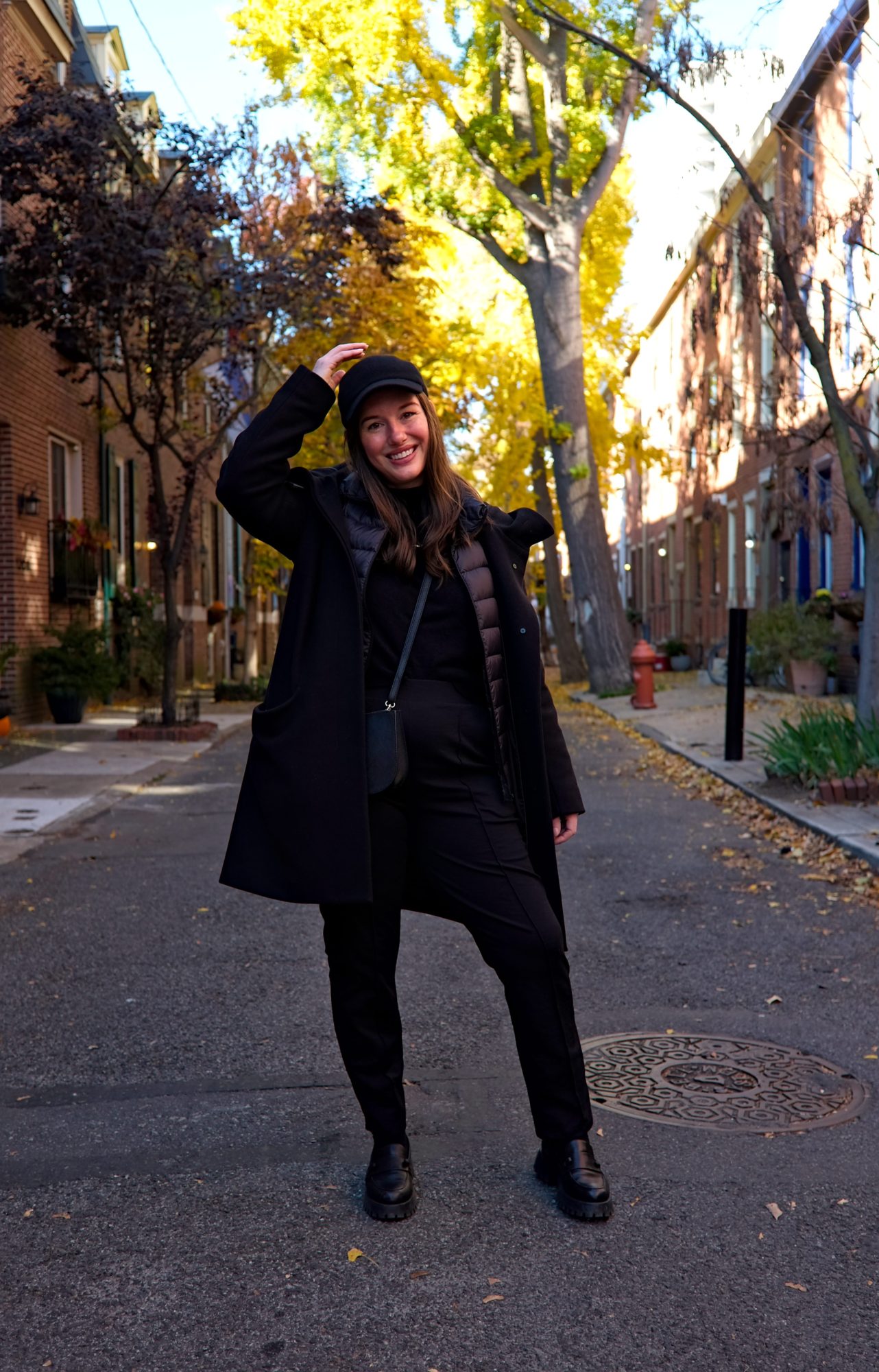 Alyssa wears all black and stands in an alley in Philadelphia