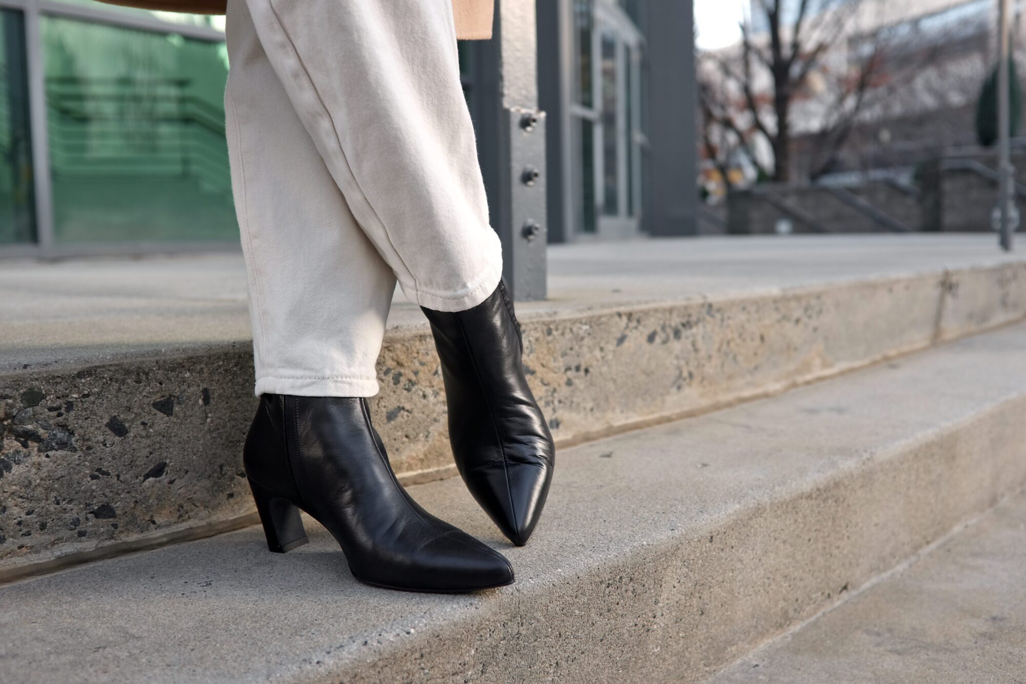 Alyssa crosses her feet while wearing the Toujours Boot